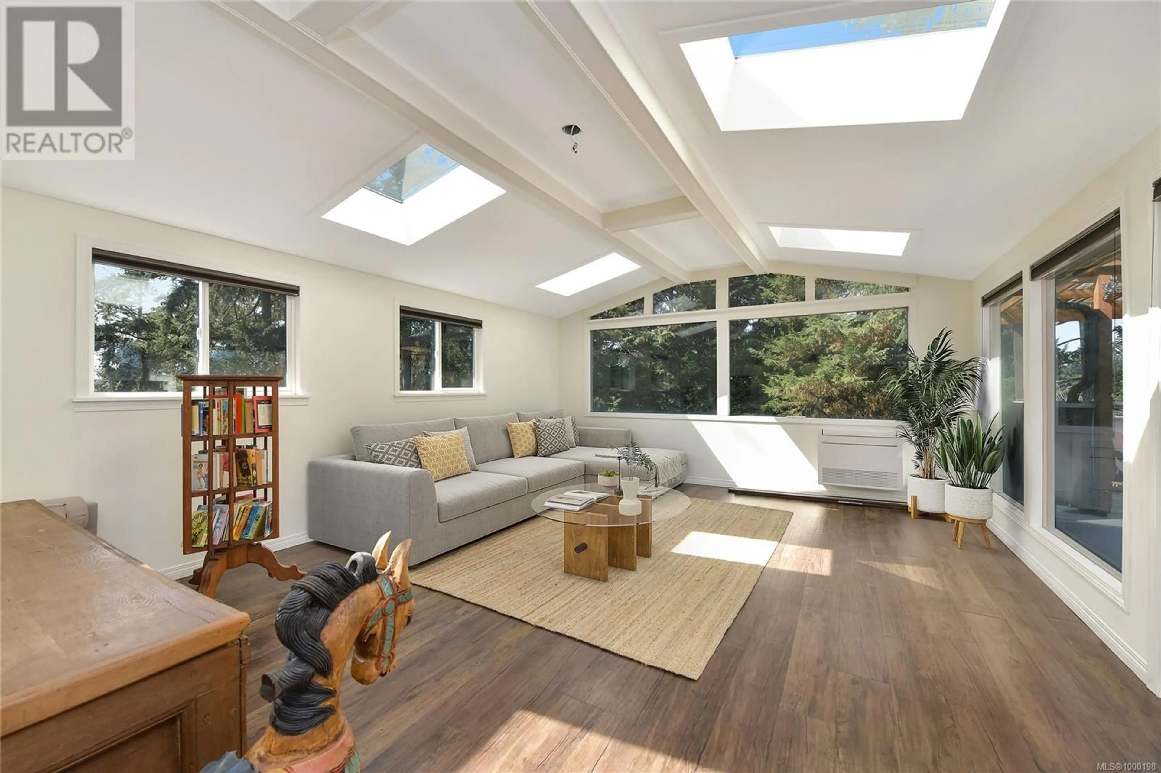 Living room with furniture, wood/laminate floor for 2582 RAINVILLE ROAD, Langford British Columbia V9B3N1