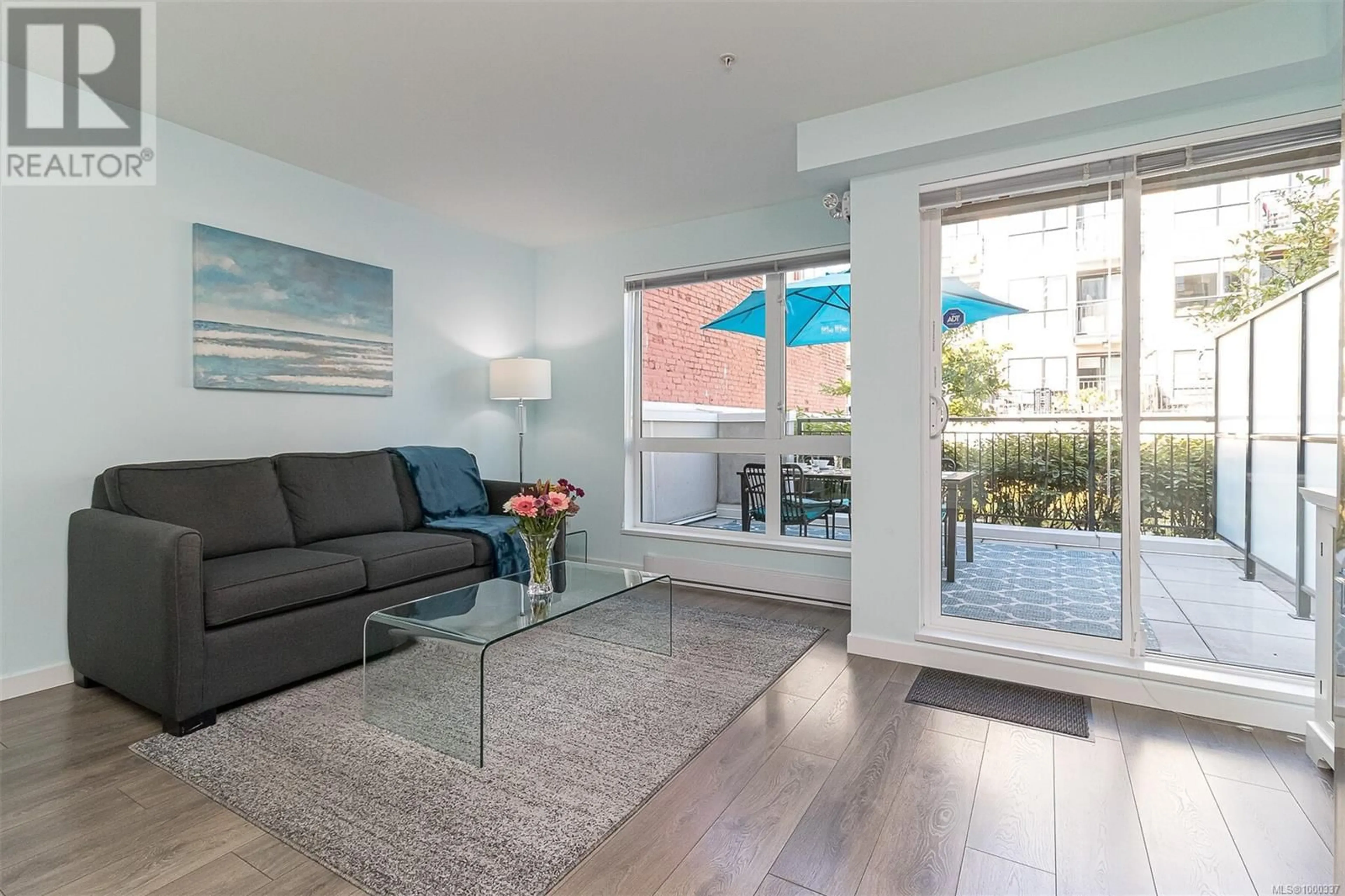 Living room with furniture, wood/laminate floor for 210 - 528 PANDORA AVENUE, Victoria British Columbia V8W0C6