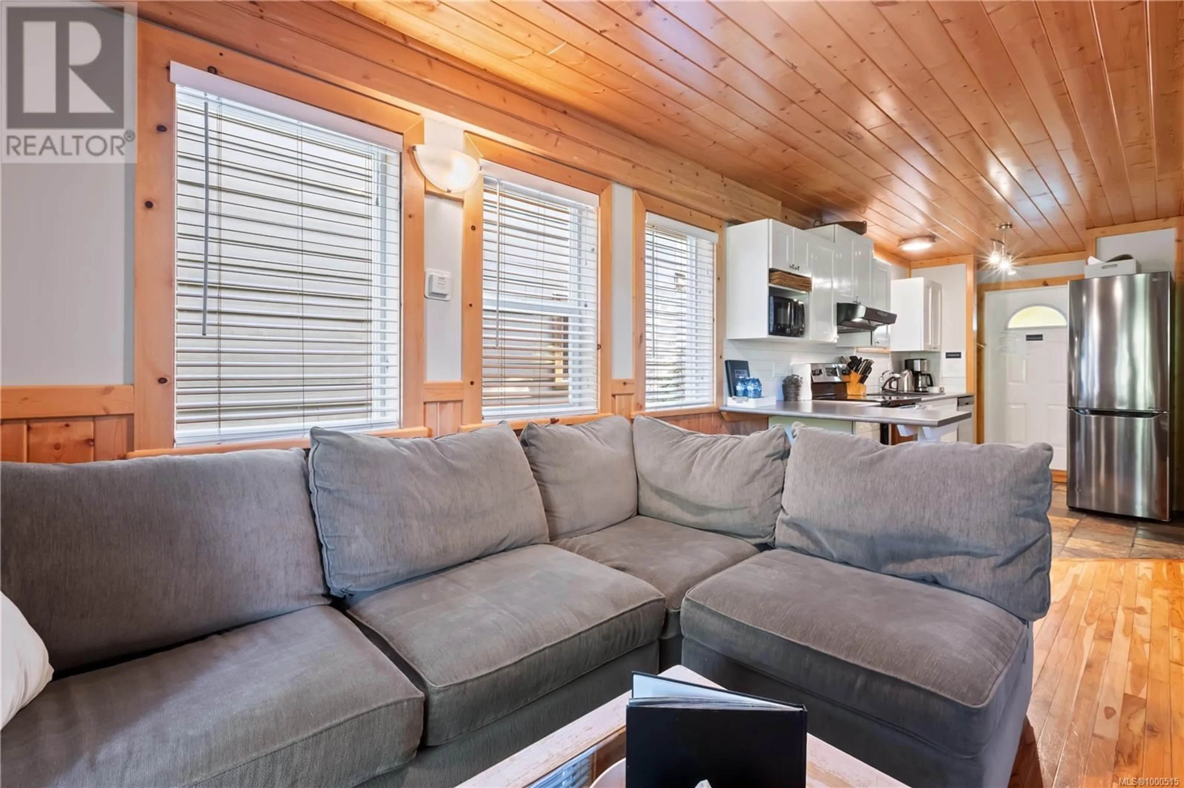 Living room with furniture, wood/laminate floor for 267 BOARDWALK BOULEVARD, Ucluelet British Columbia V0R3A0