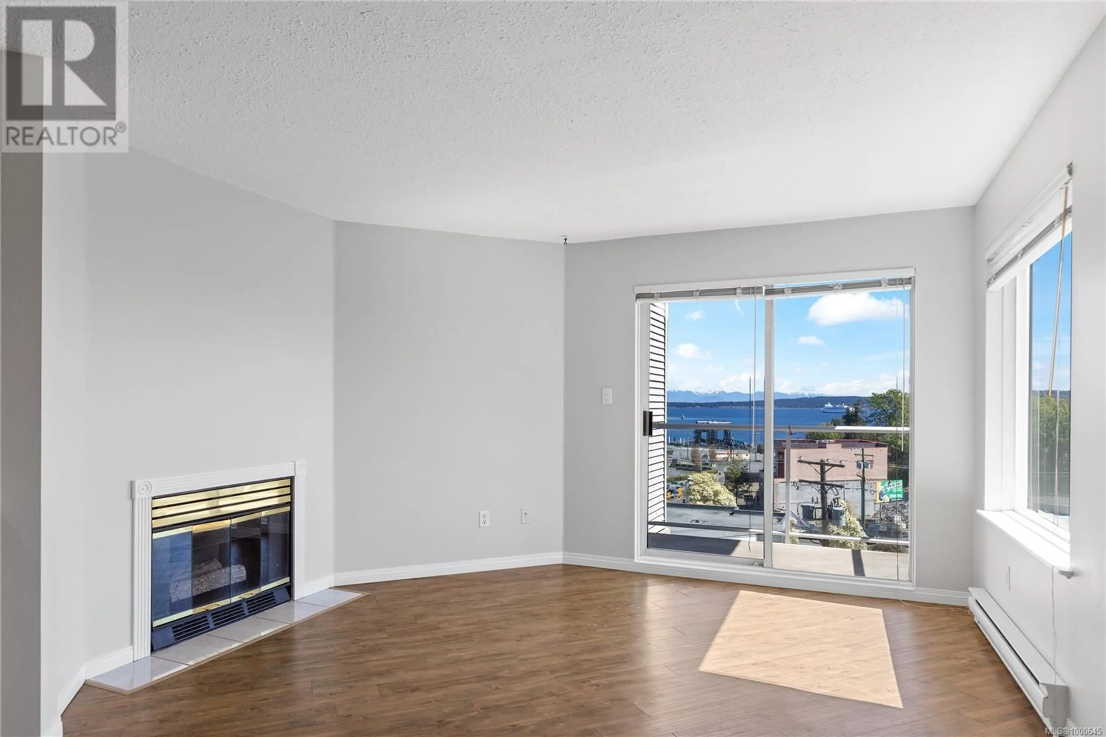 Living room with furniture, wood/laminate floor for 202 - 315 HECATE STREET, Nanaimo British Columbia V9R2J9