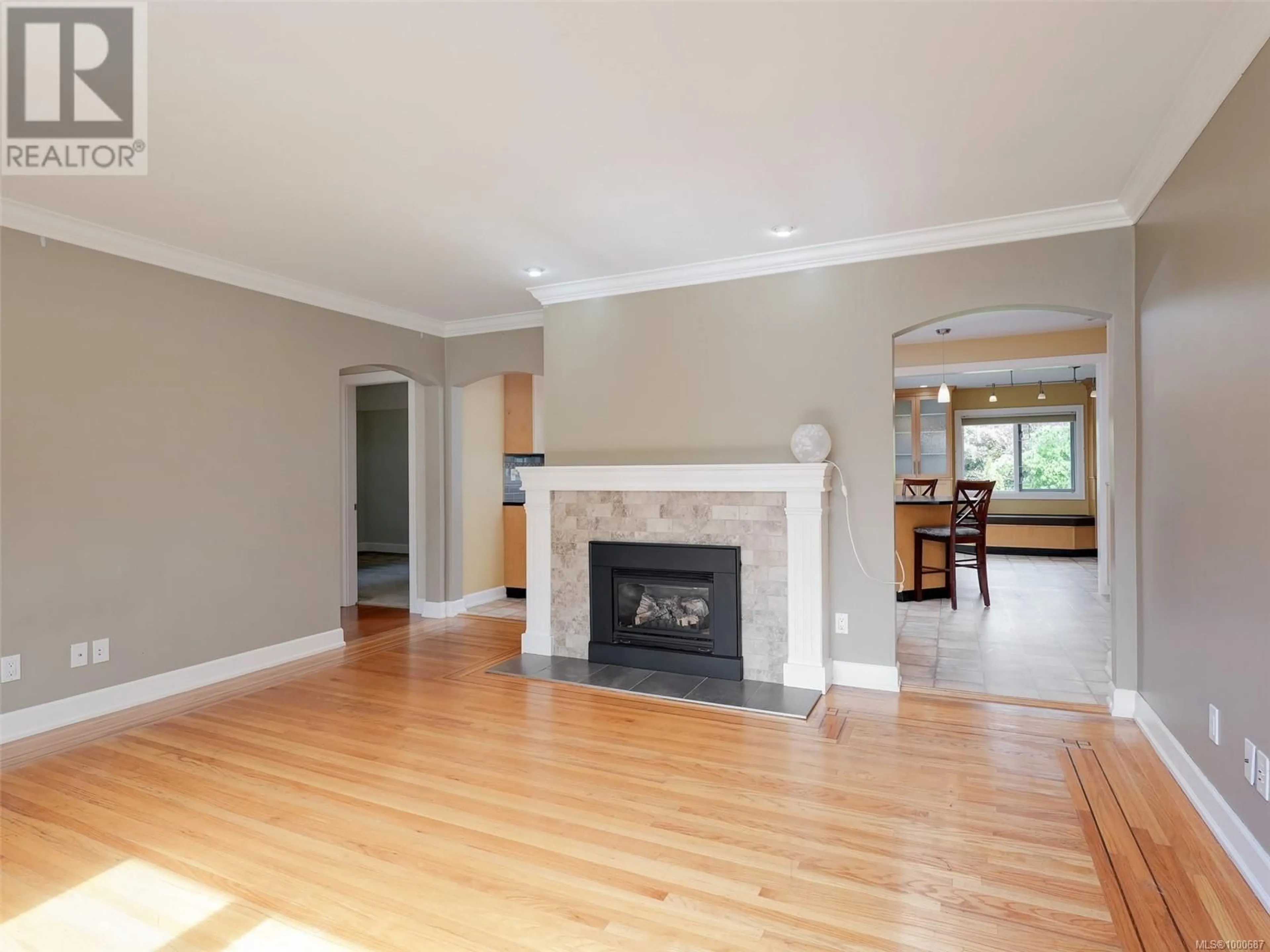 Living room with furniture, wood/laminate floor for 4406 TORQUAY DRIVE, Saanich British Columbia V8N3L4