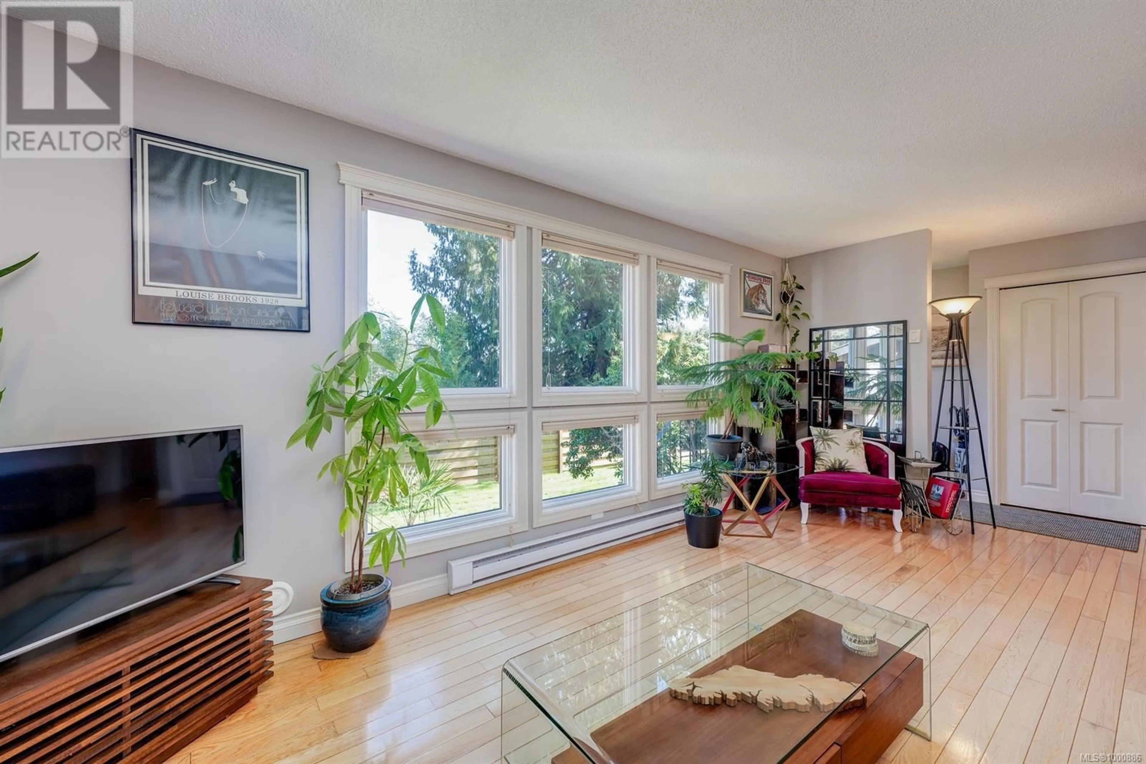 Living room with furniture, wood/laminate floor for 2392 OTTER POINT ROAD, Sooke British Columbia V9Z0H9