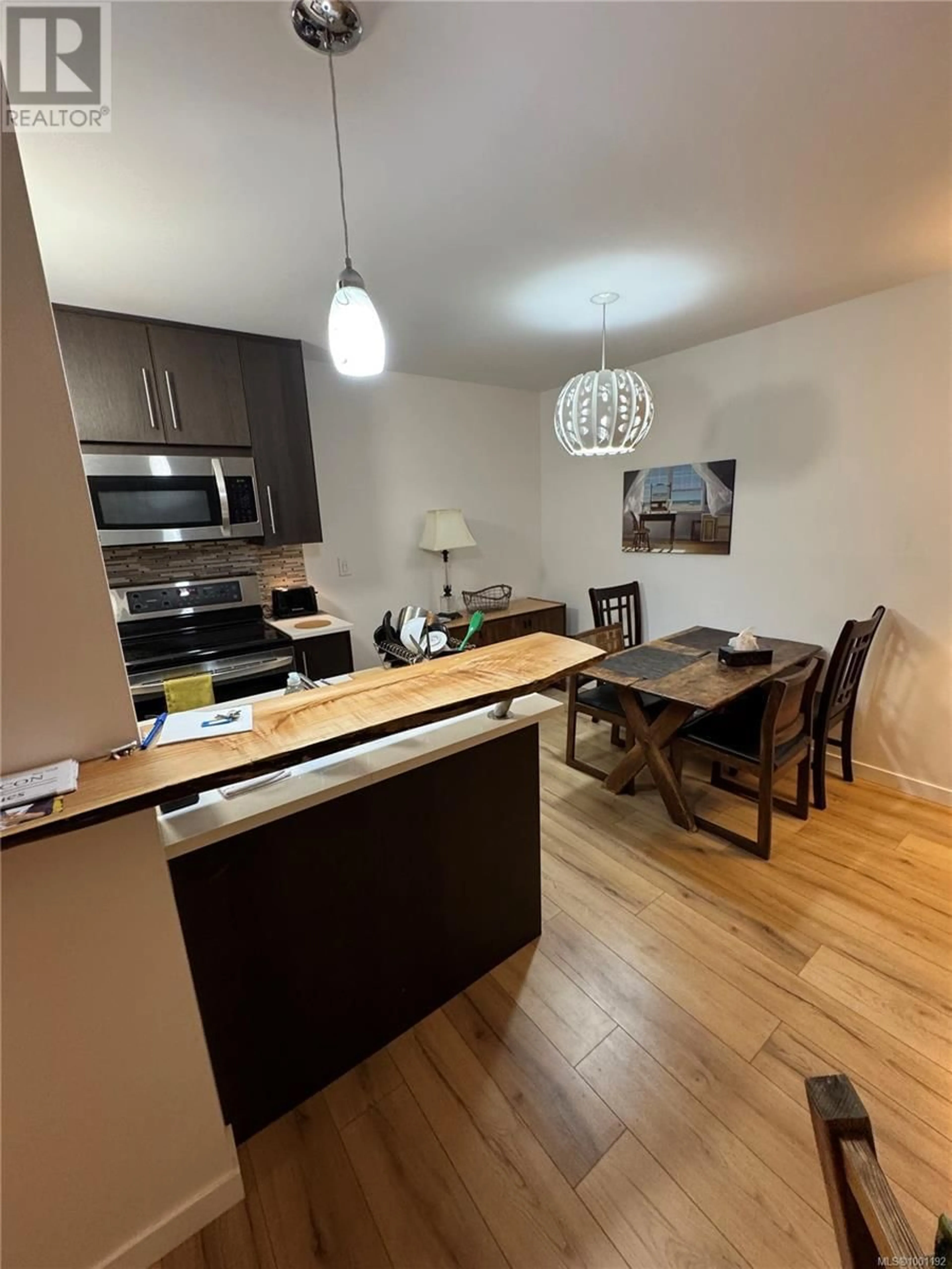 Open concept kitchen, wood/laminate floor for 101 - 964 HEYWOOD AVENUE, Victoria British Columbia V8V2Y5