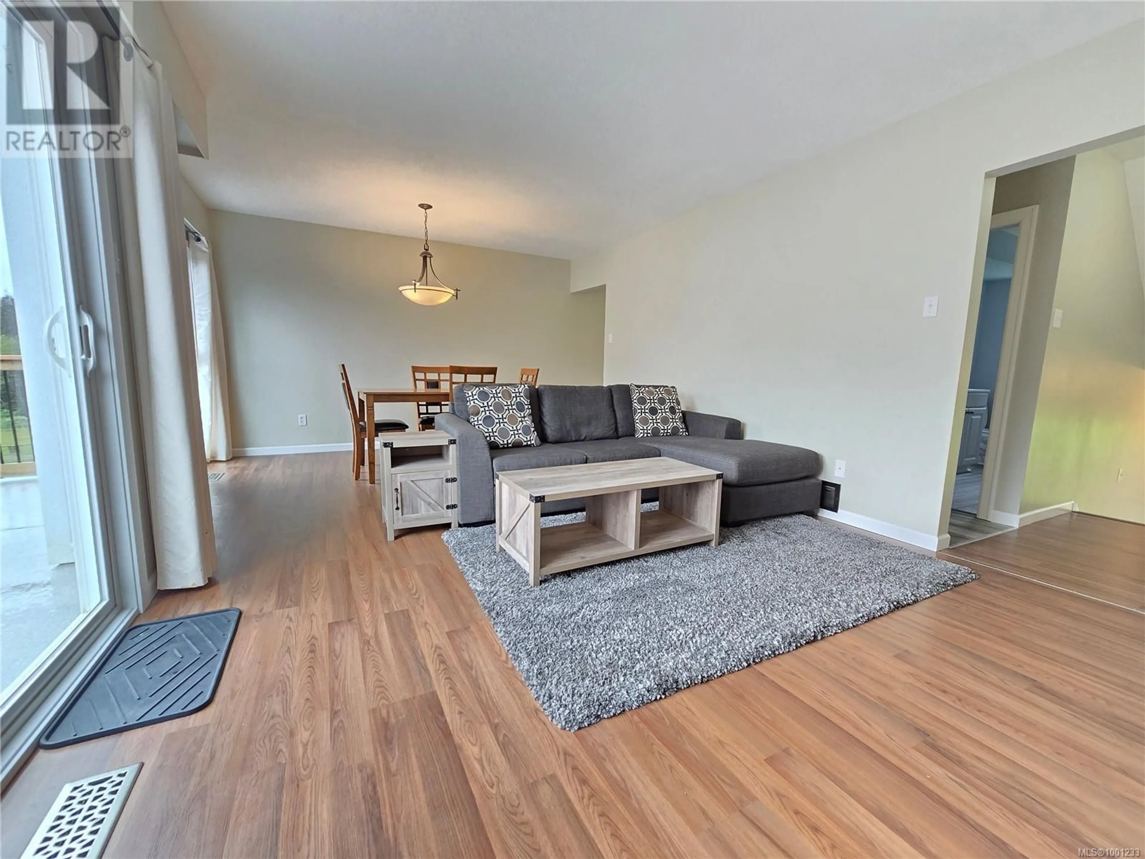 Living room with furniture, wood/laminate floor for 69 MCKAY CRESCENT, Port Alice British Columbia V0N2N0