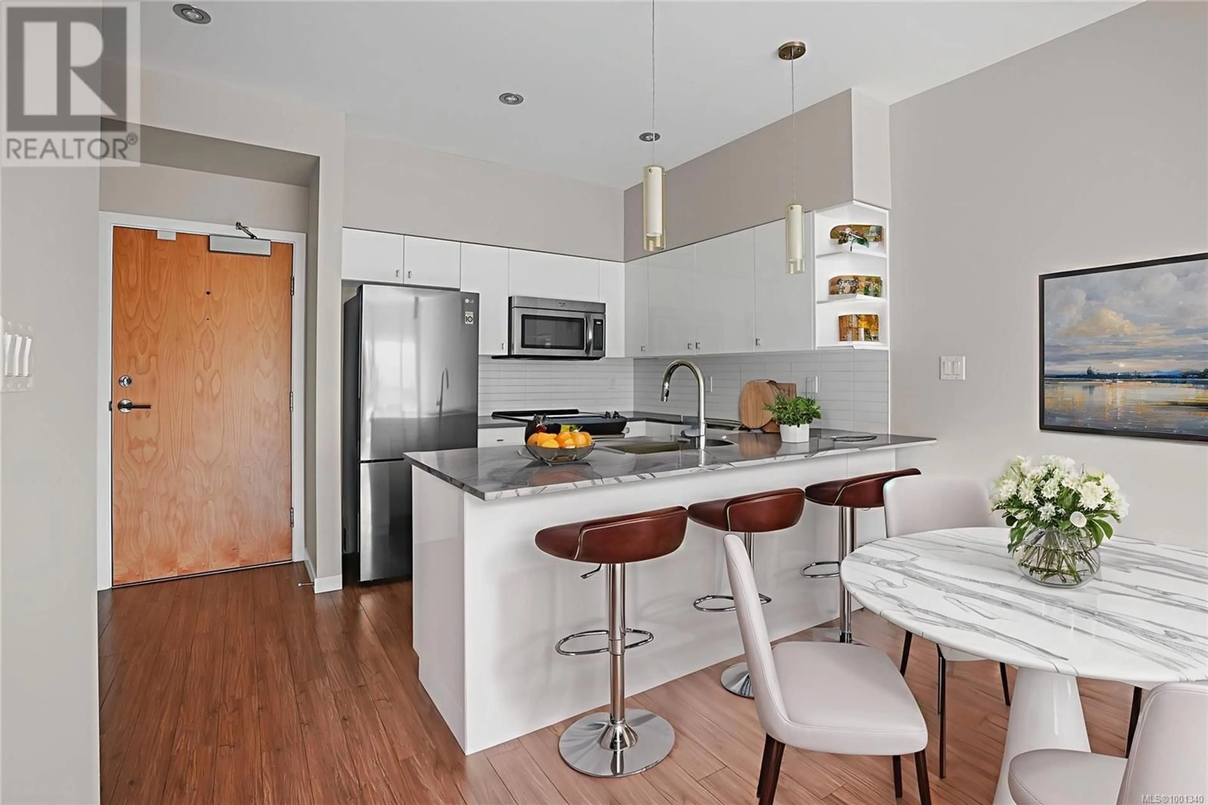 Open concept kitchen, wood/laminate floor for 205 - 785 TYEE ROAD, Victoria British Columbia V9A0G2