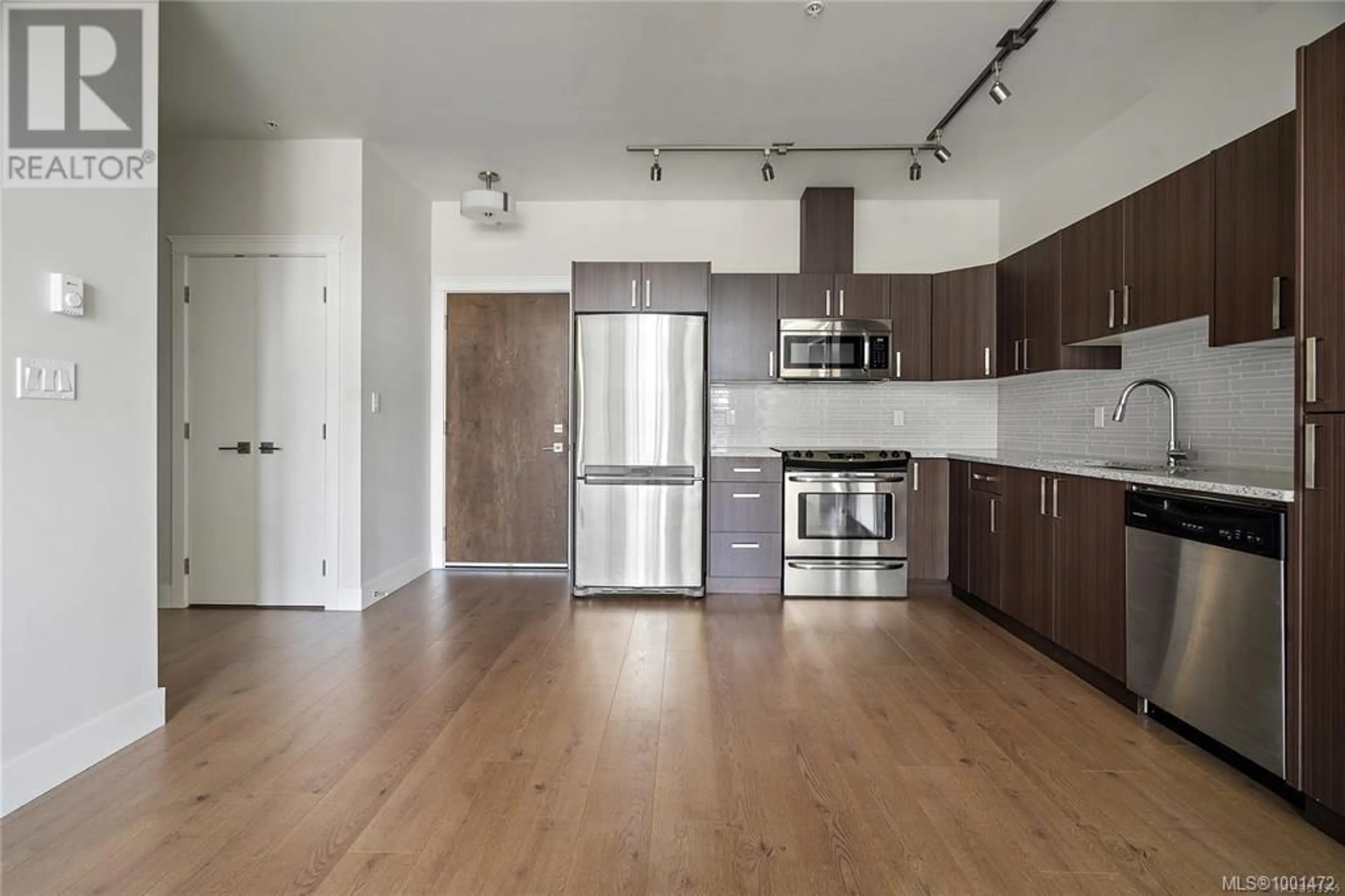 Open concept kitchen, wood/laminate floor for 406 - 1900 WATKISS WAY, View Royal British Columbia V9B0S8