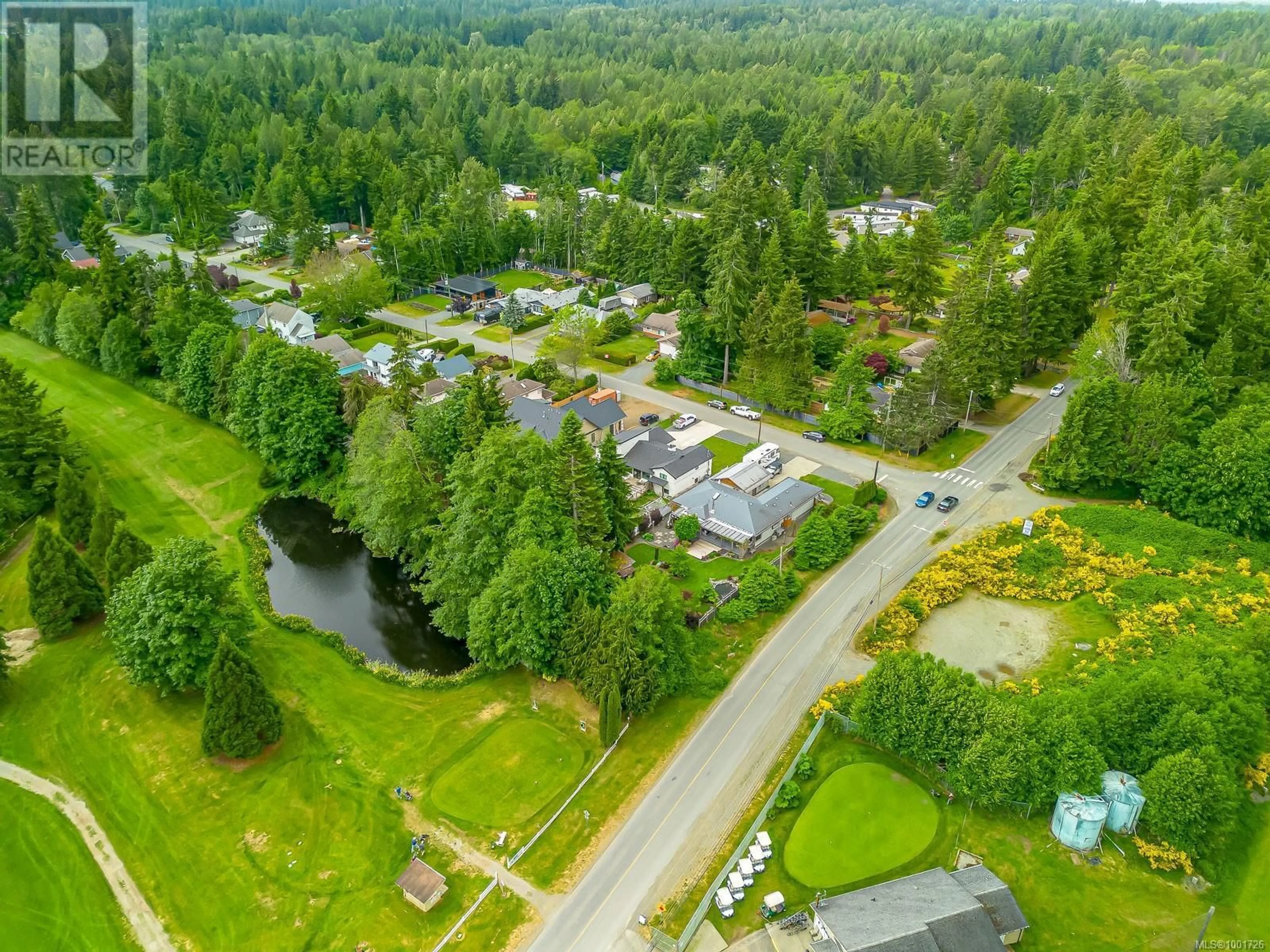 A pic from outside/outdoor area/front of a property/back of a property/a pic from drone, unknown for 8998 MCLAREY AVENUE, Black Creek British Columbia V9J1A2