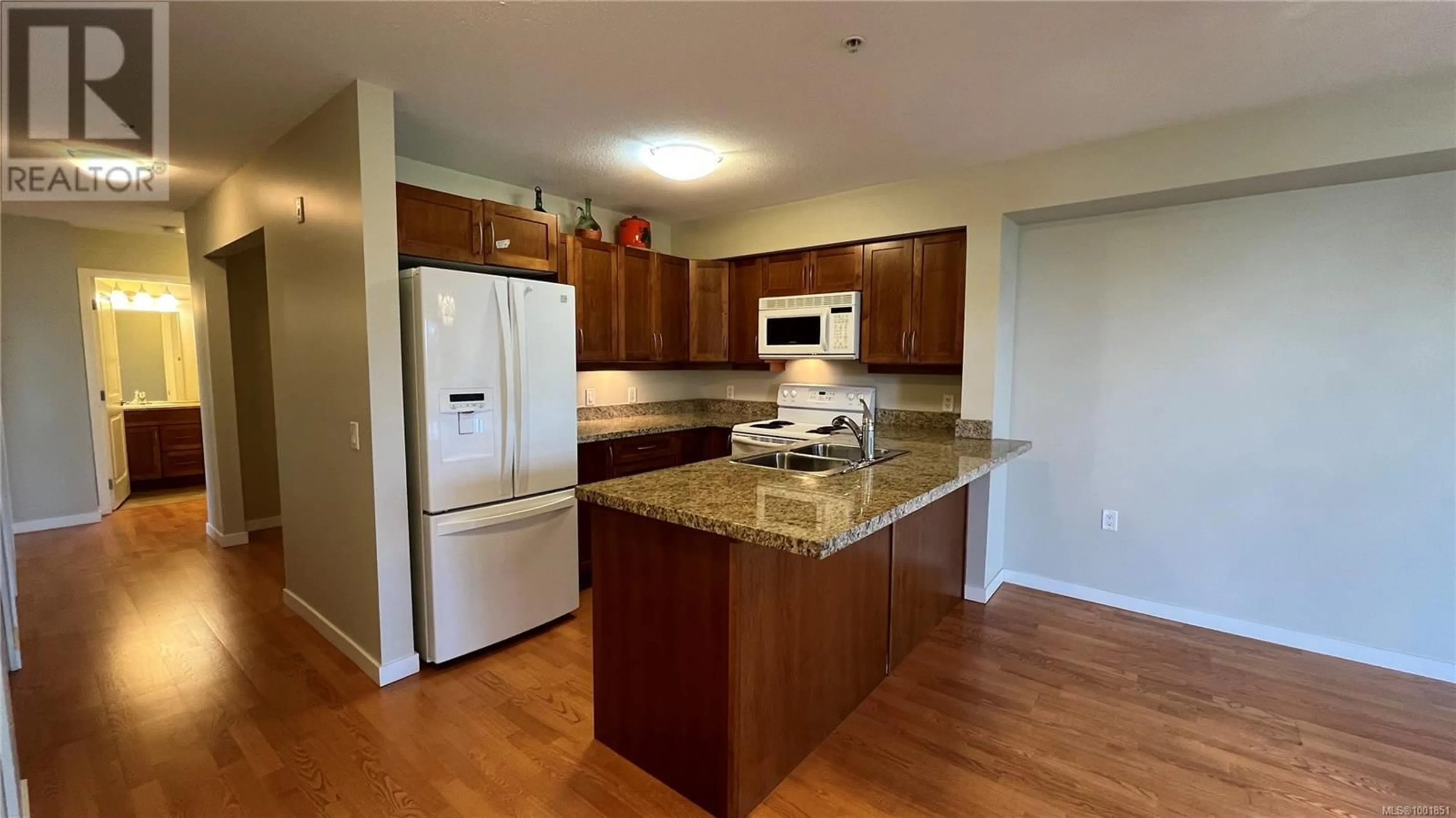 Open concept kitchen, wood/laminate floor for 403 - 297 HIRST AVENUE WEST, Parksville British Columbia V9P0A4