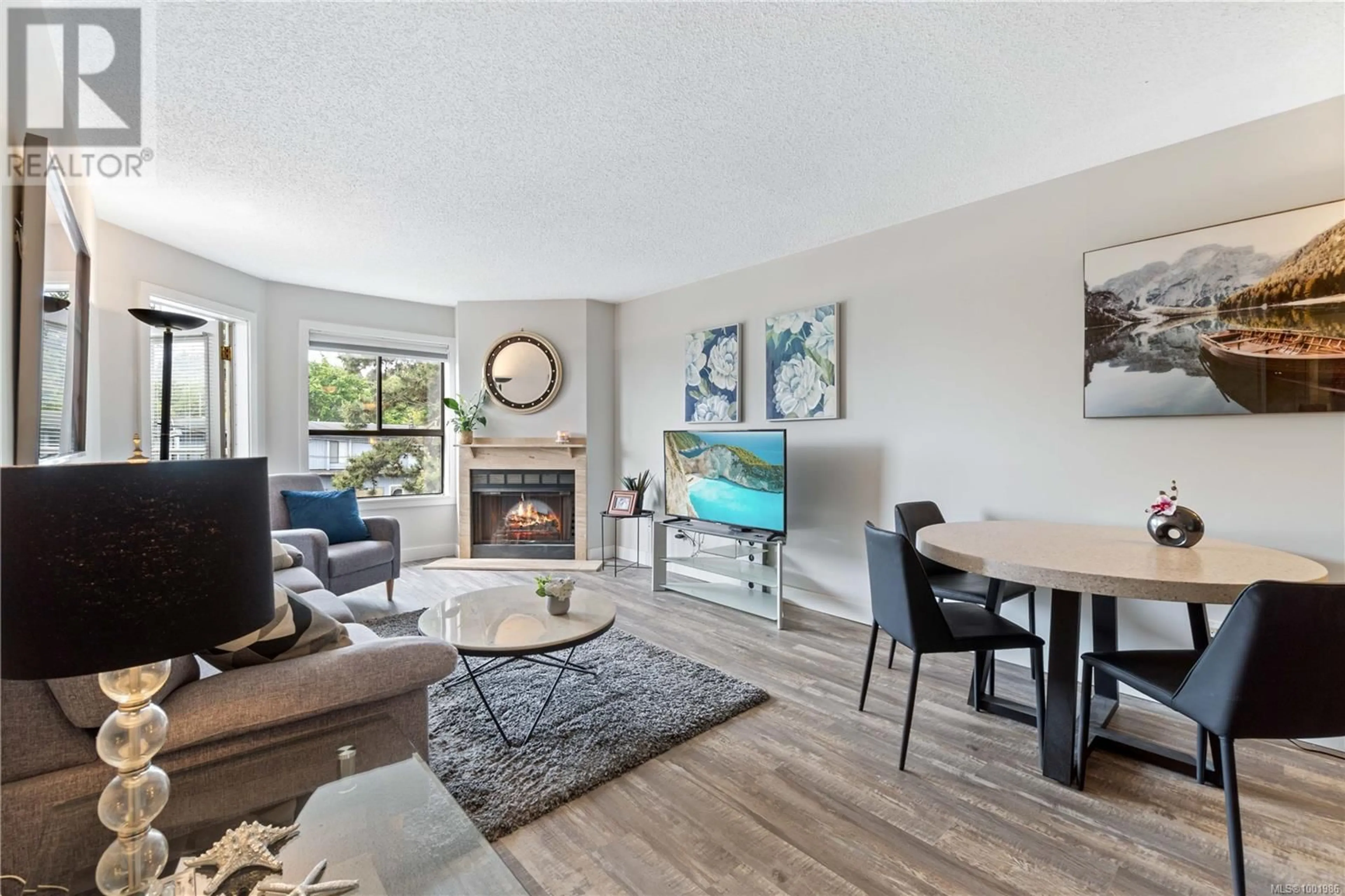 Living room with furniture, wood/laminate floor for 213 - 2815 DEPARTURE BAY ROAD, Nanaimo British Columbia V9S5P4