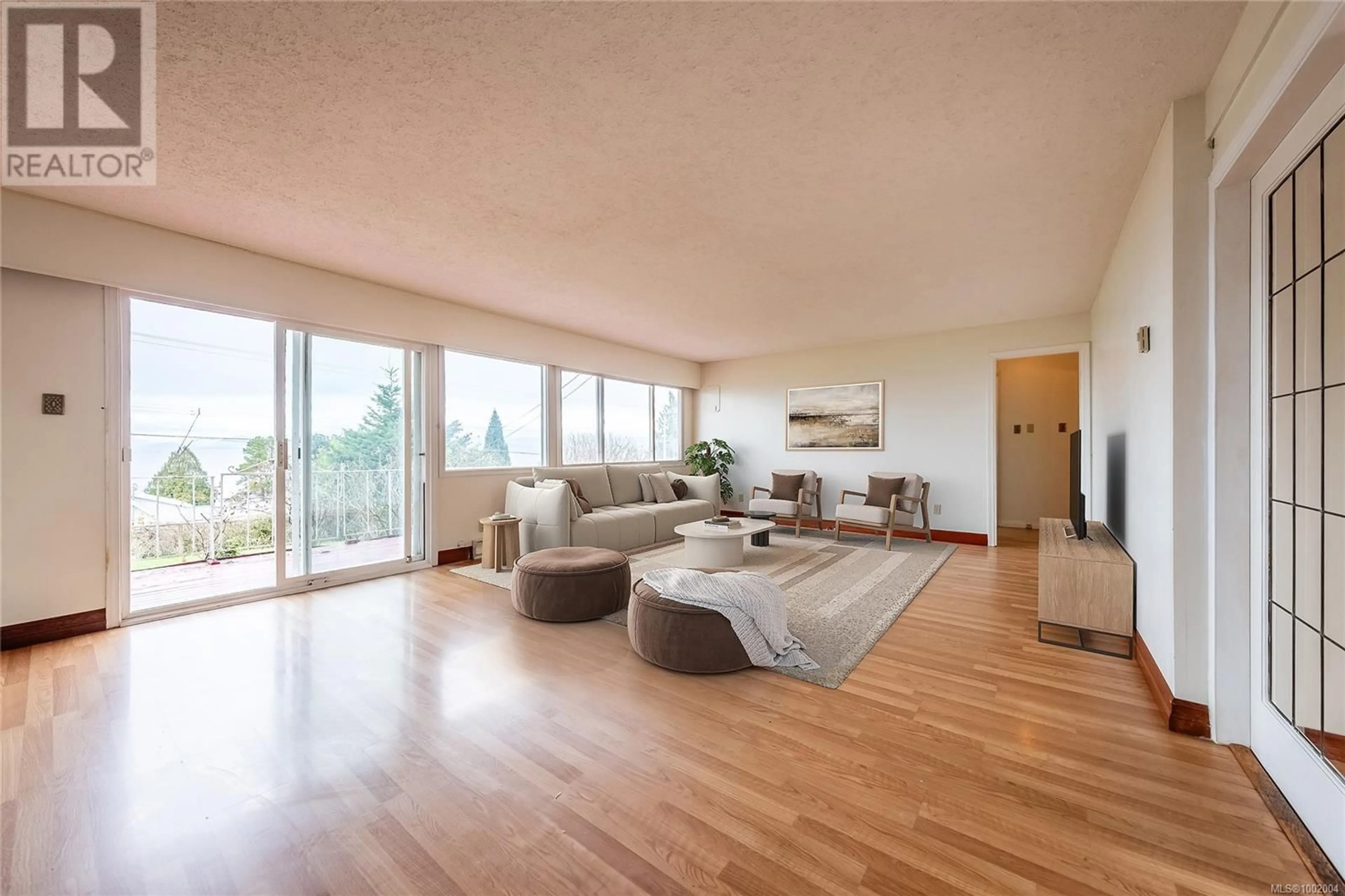 Living room with furniture, wood/laminate floor for 7034 LAVENDER ROAD, Lantzville British Columbia V0R2H0