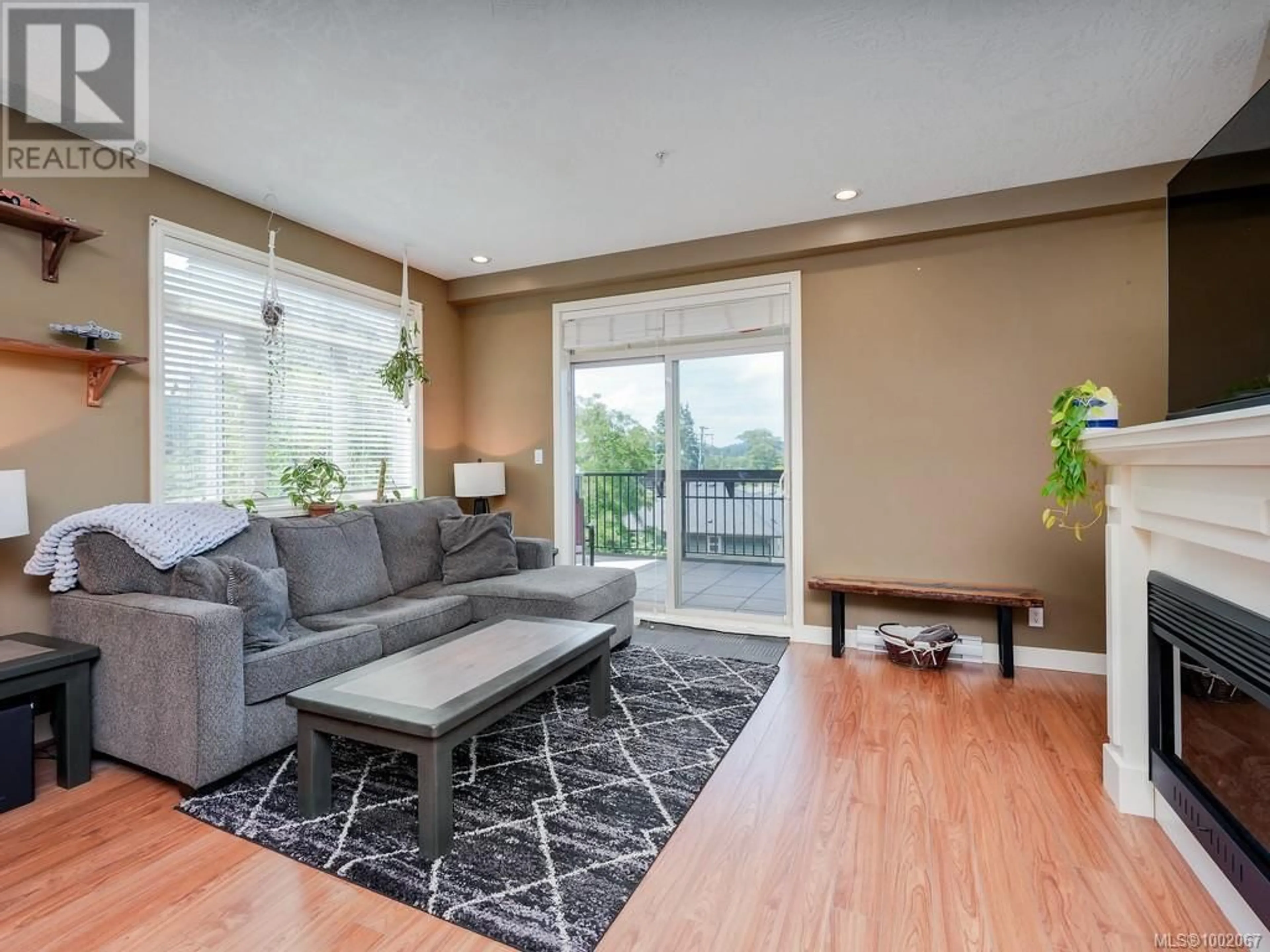 Living room with furniture, wood/laminate floor for 310 - 623 TREANOR AVENUE, Langford British Columbia V9B0B1