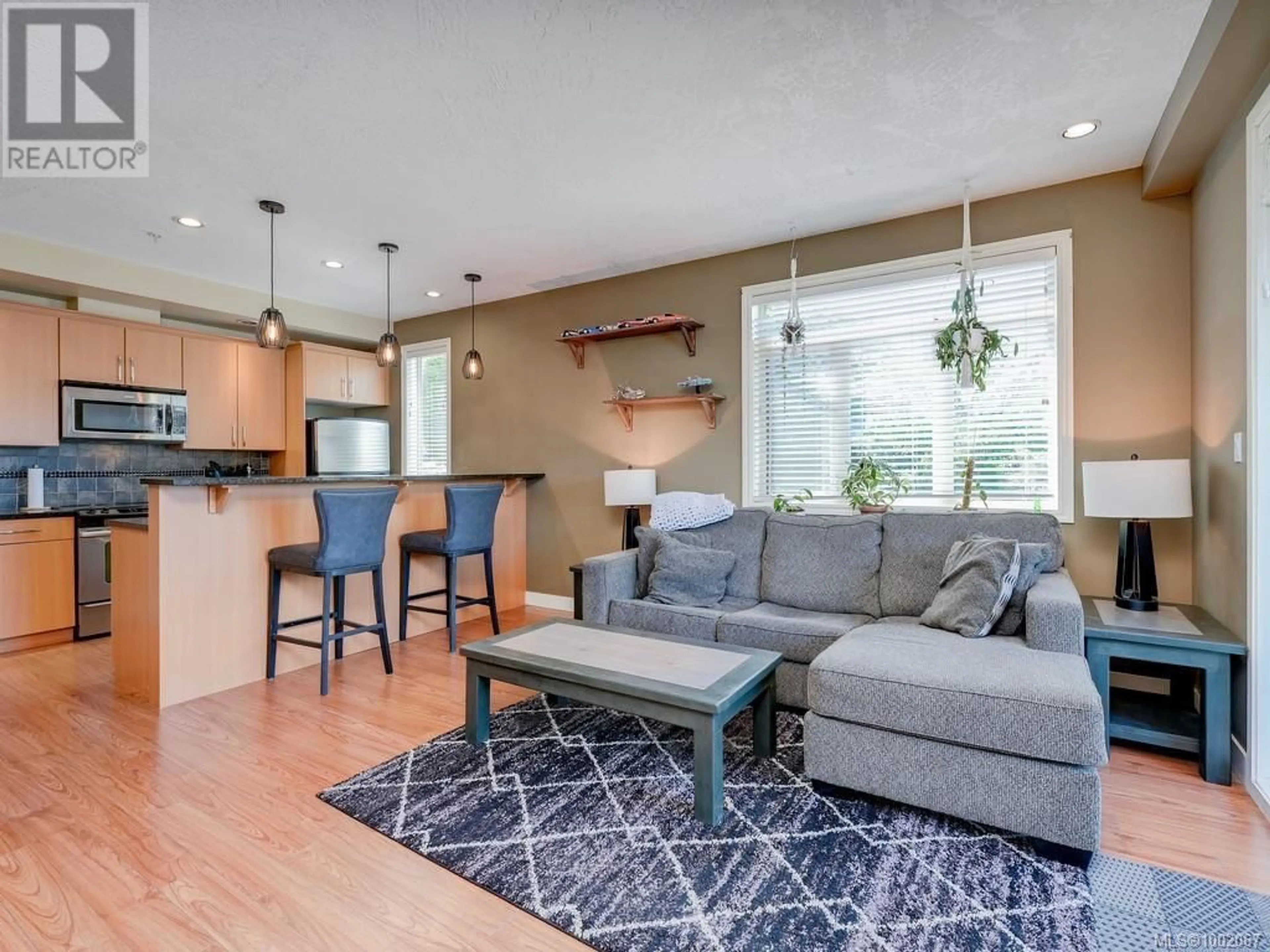Living room with furniture, wood/laminate floor for 310 - 623 TREANOR AVENUE, Langford British Columbia V9B0B1
