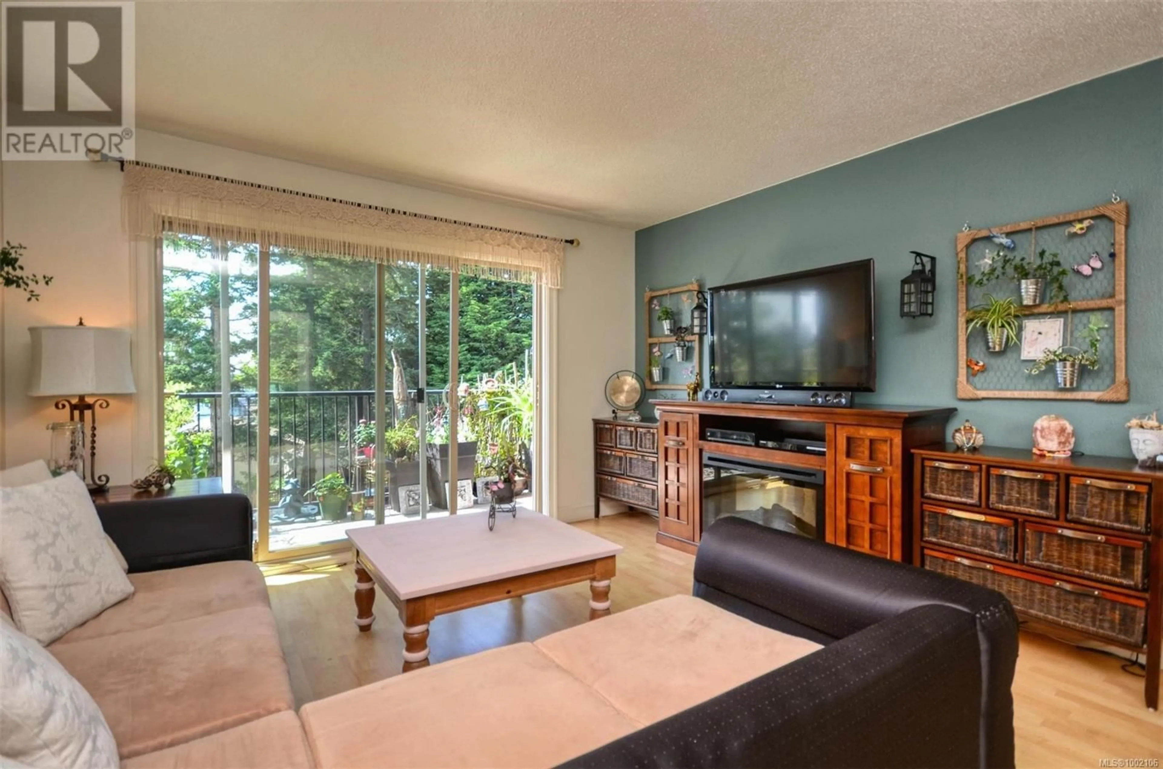Living room with furniture, wood/laminate floor for 303 - 2427 AMHERST AVENUE, Sidney British Columbia V8L2H1