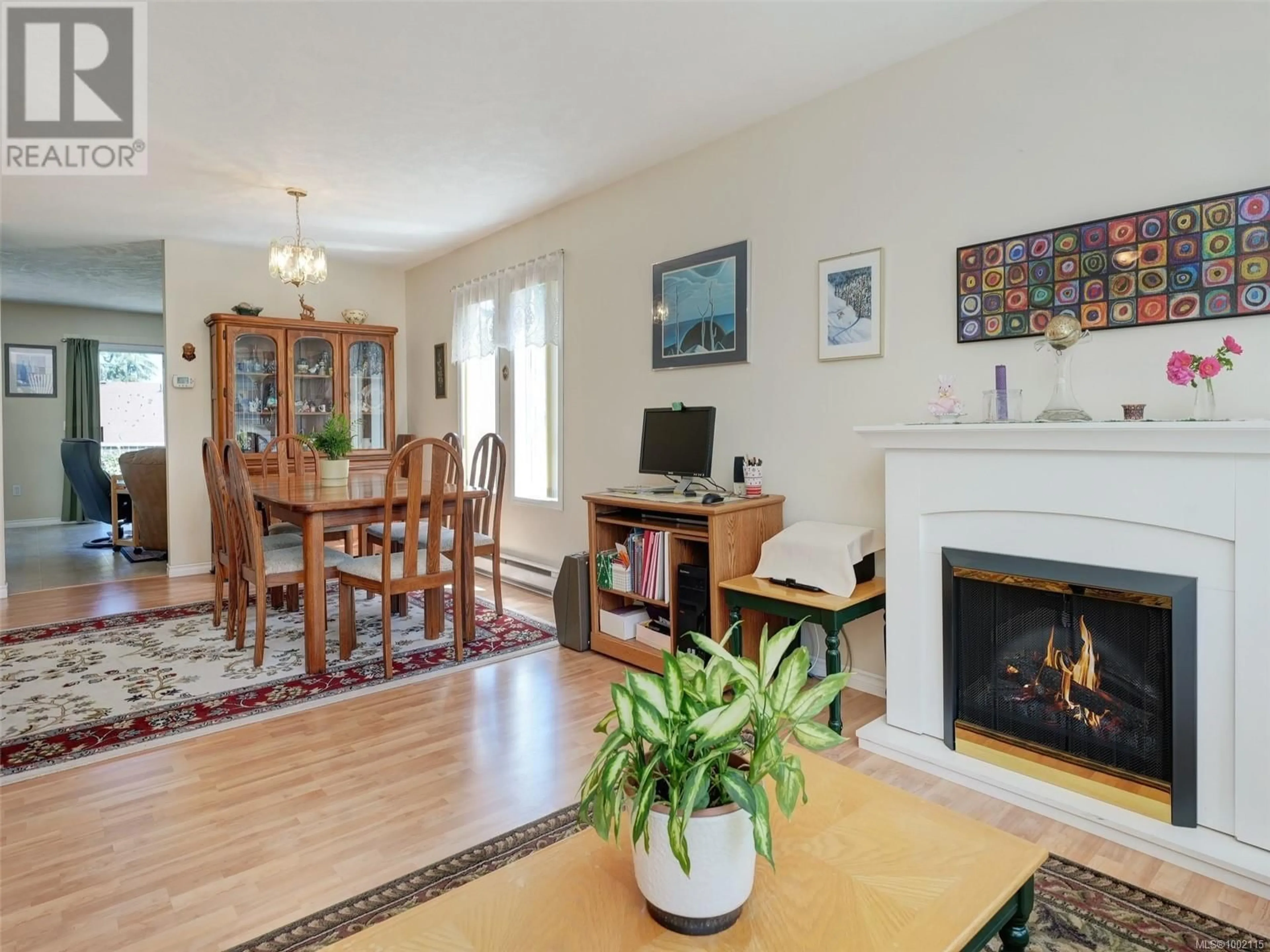 Living room with furniture, wood/laminate floor for 6797 WENDONNA PLACE, Central Saanich British Columbia V8M1A6