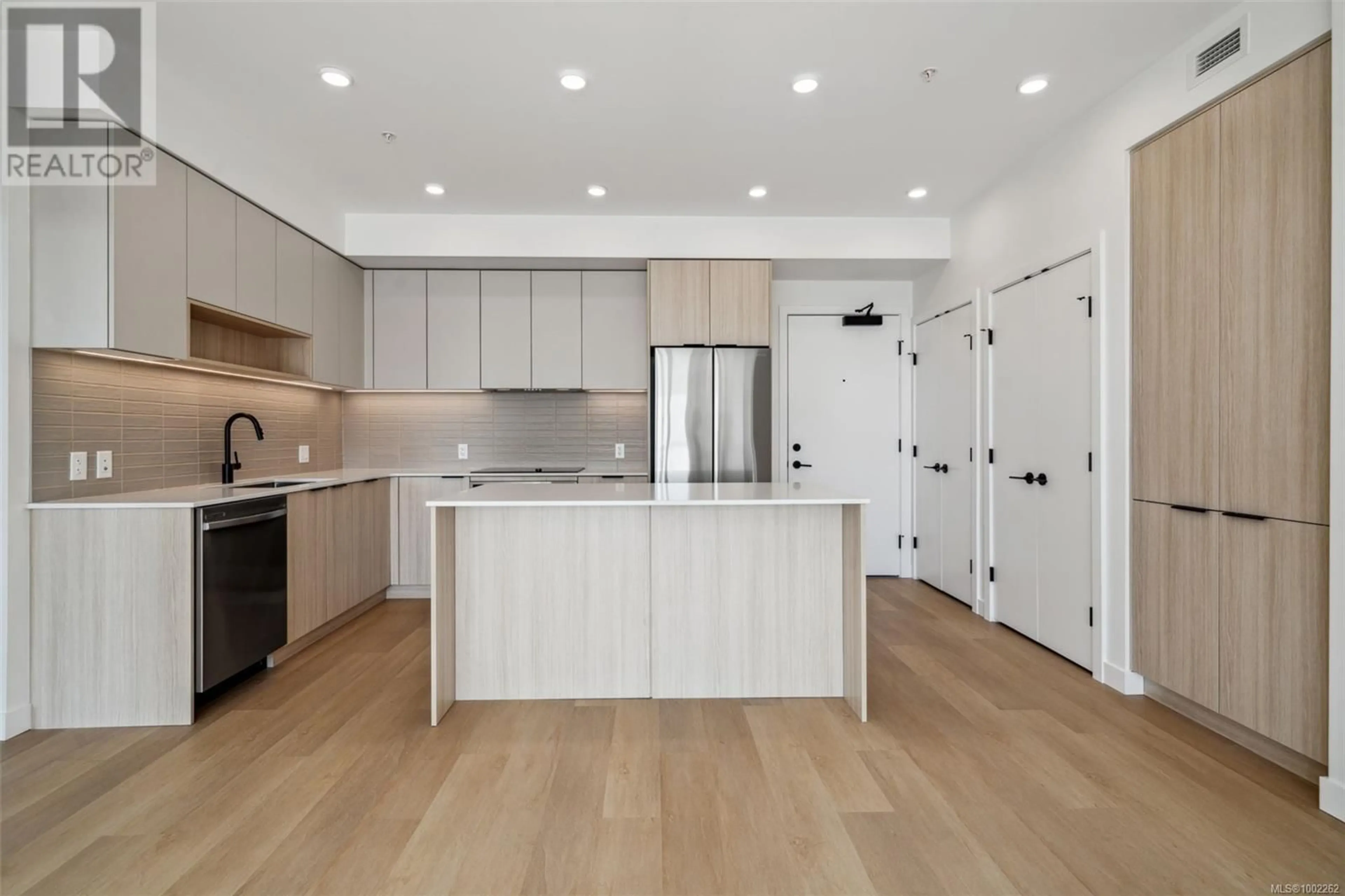 Open concept kitchen, wood/laminate floor for 105 - 3564B RYDER HESJEDAL WAY, Colwood British Columbia V9C0V3