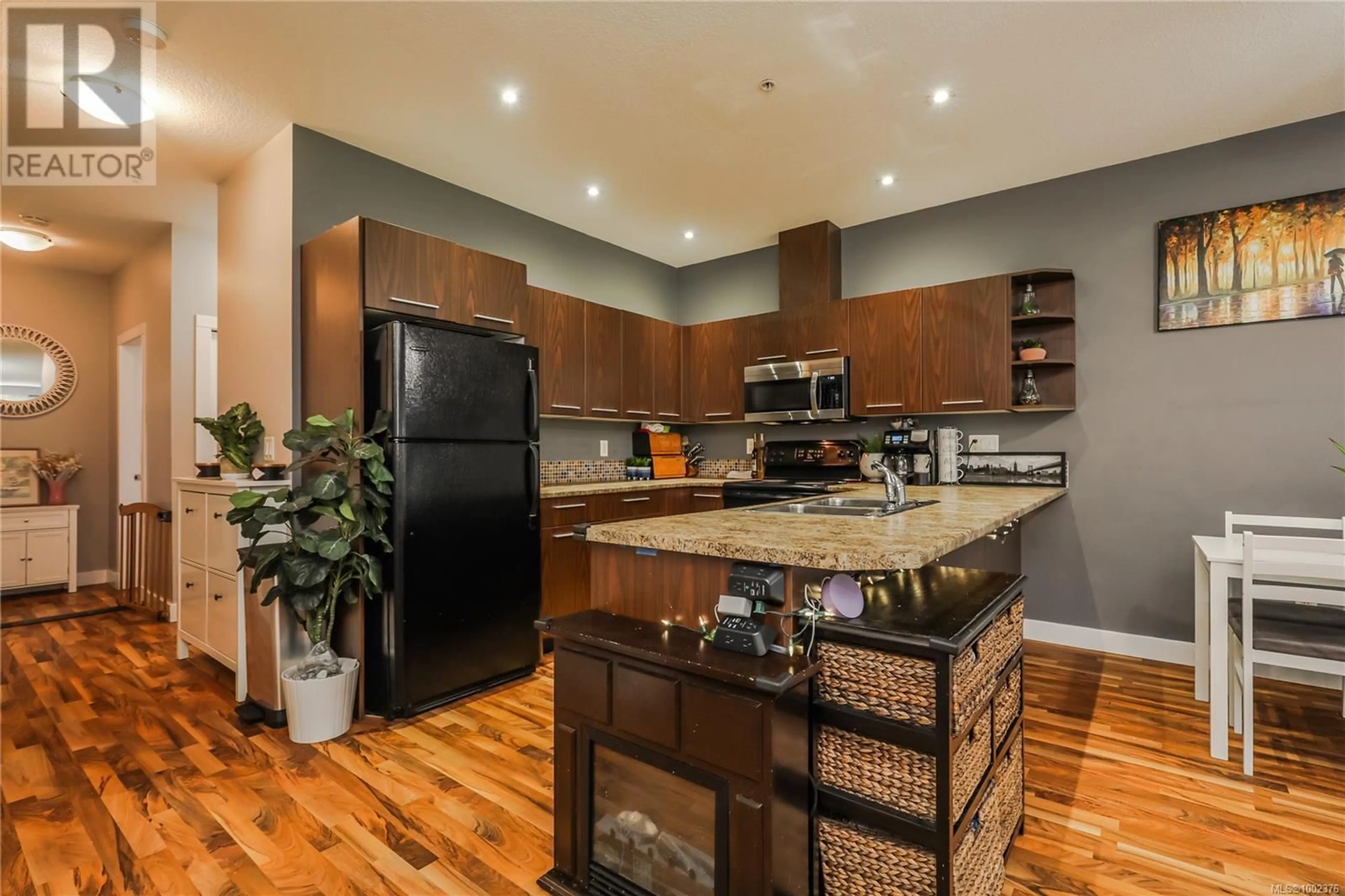 Open concept kitchen, wood/laminate floor for 6002 LEAH LANE, Nanaimo British Columbia V9V1W7
