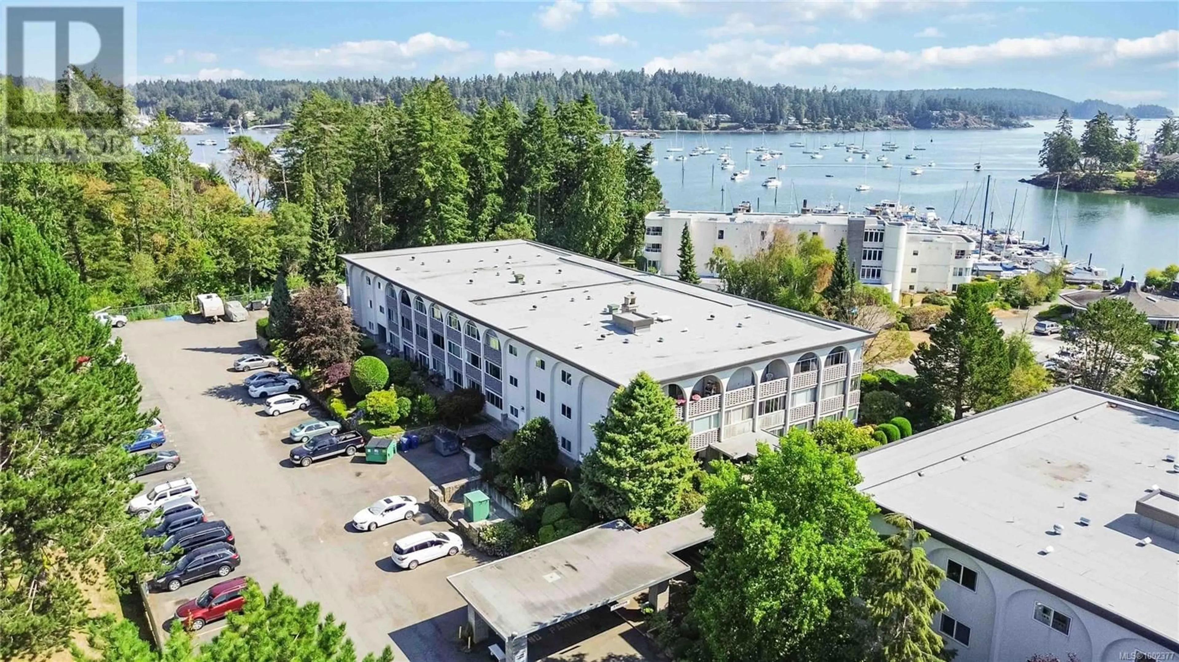 A pic from outside/outdoor area/front of a property/back of a property/a pic from drone, water/lake/river/ocean view for 104 - 2050 WHITE BIRCH ROAD, Sidney British Columbia V8L2R1