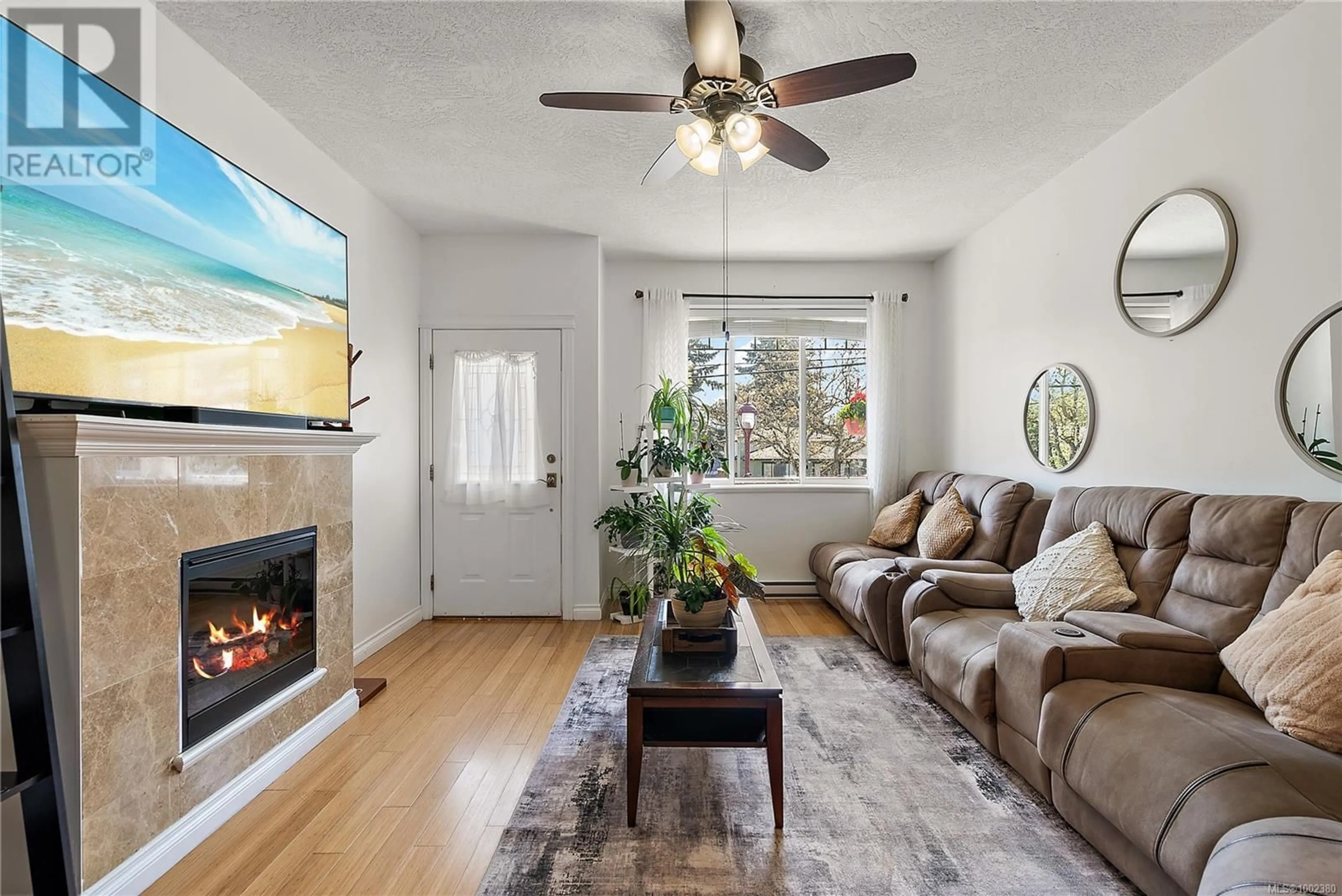 Living room with furniture, wood/laminate floor for 205 - 2680 PEATT ROAD, Langford British Columbia V9B3V1