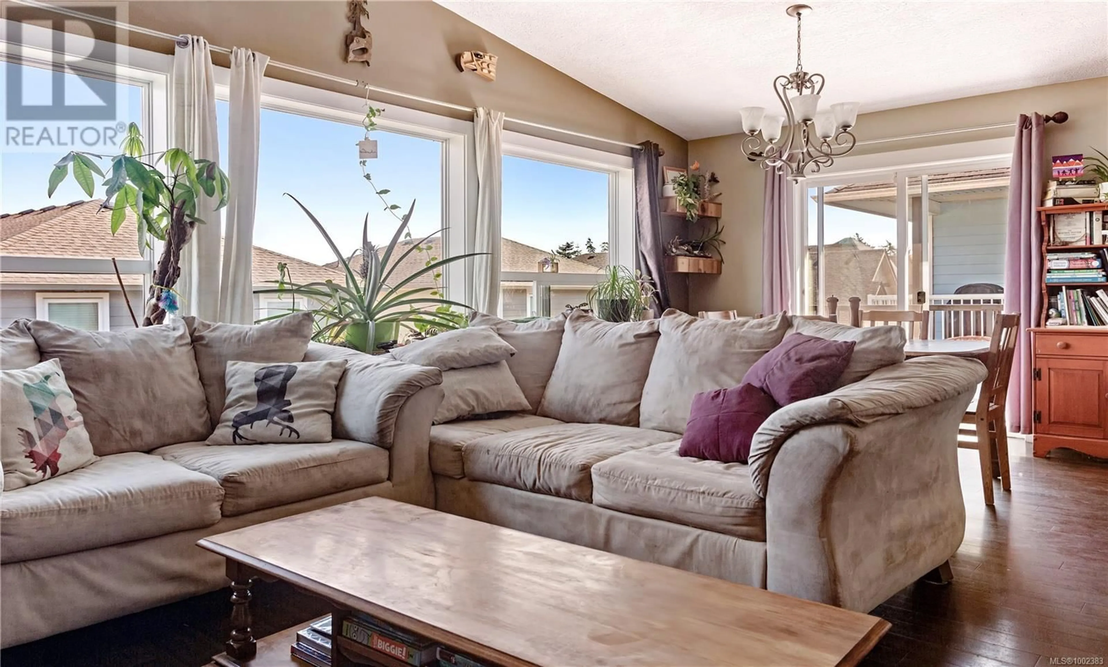 Living room with furniture, wood/laminate floor for 6561 ARRANWOOD DRIVE, Sooke British Columbia V9Z0W4