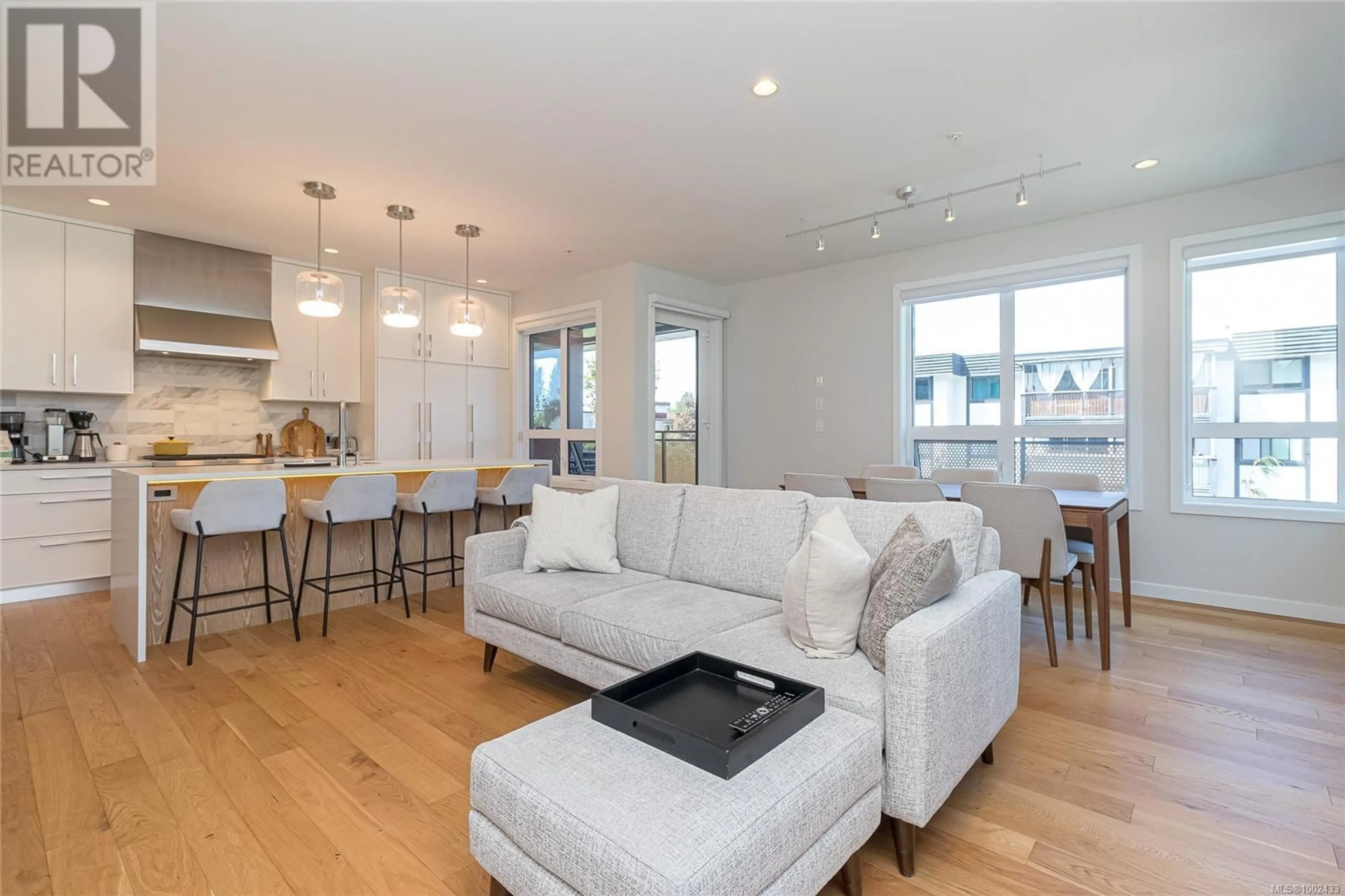 Living room with furniture, wood/laminate floor for 208 - 1018 PENTRELEW PLACE, Victoria British Columbia V8V4J4