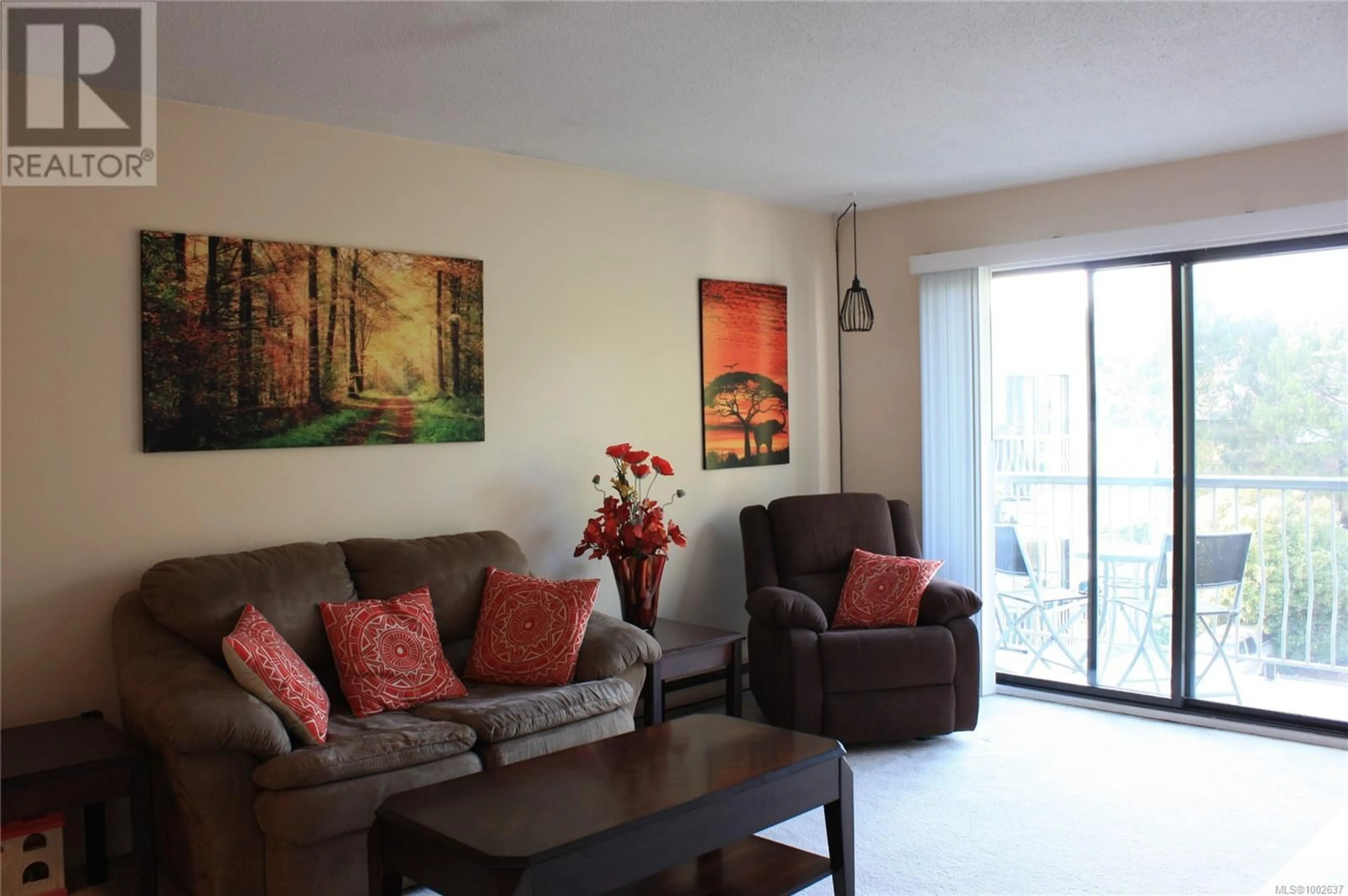 Living room with furniture, wood/laminate floor for 410 - 900 TOLMIE AVENUE, Saanich British Columbia V8X3W6