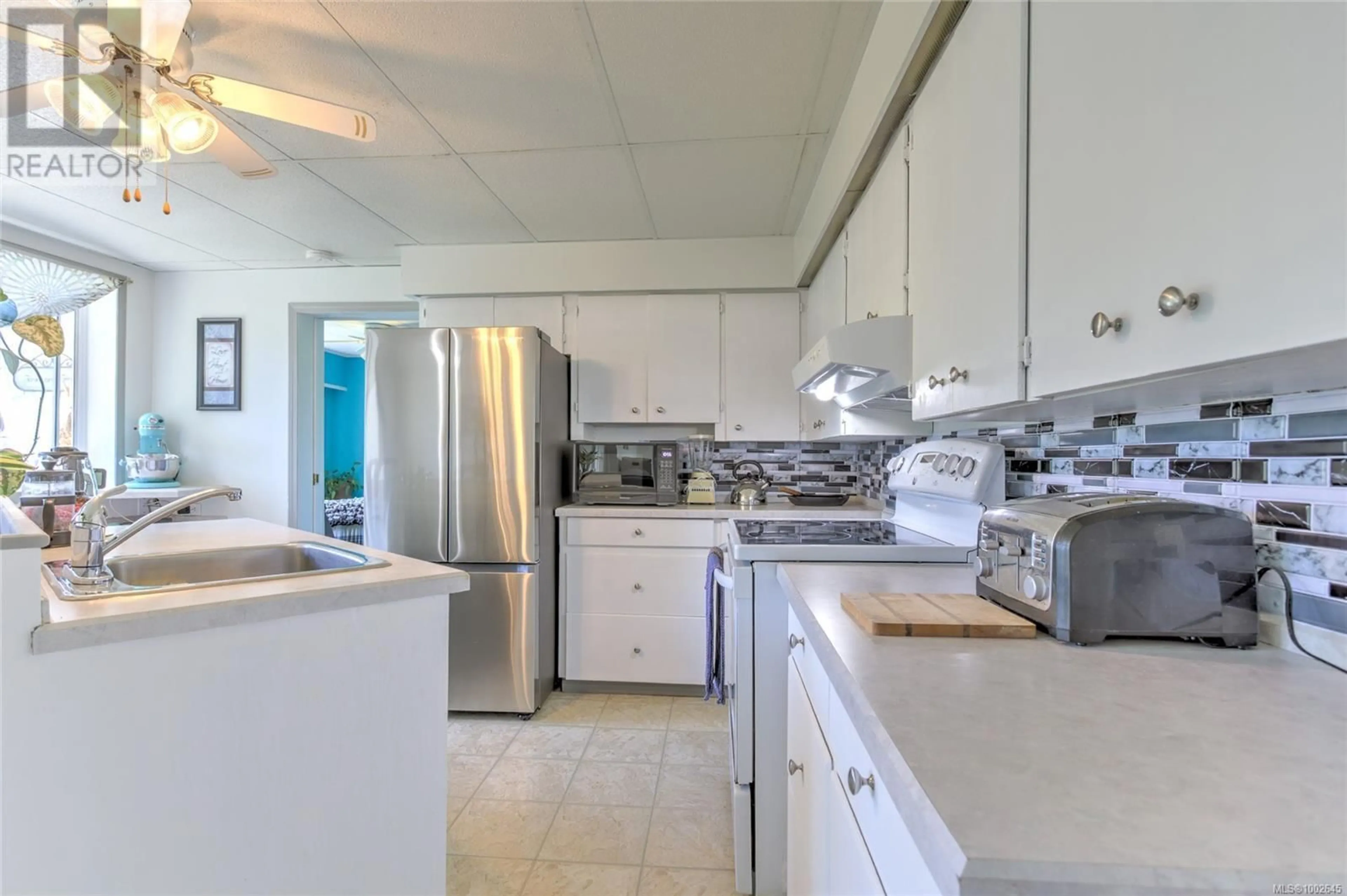 Kitchen with laundary machines, ceramic/tile floor for 249 GRANTS LAKE ROAD, Lake Cowichan British Columbia V0R2G0