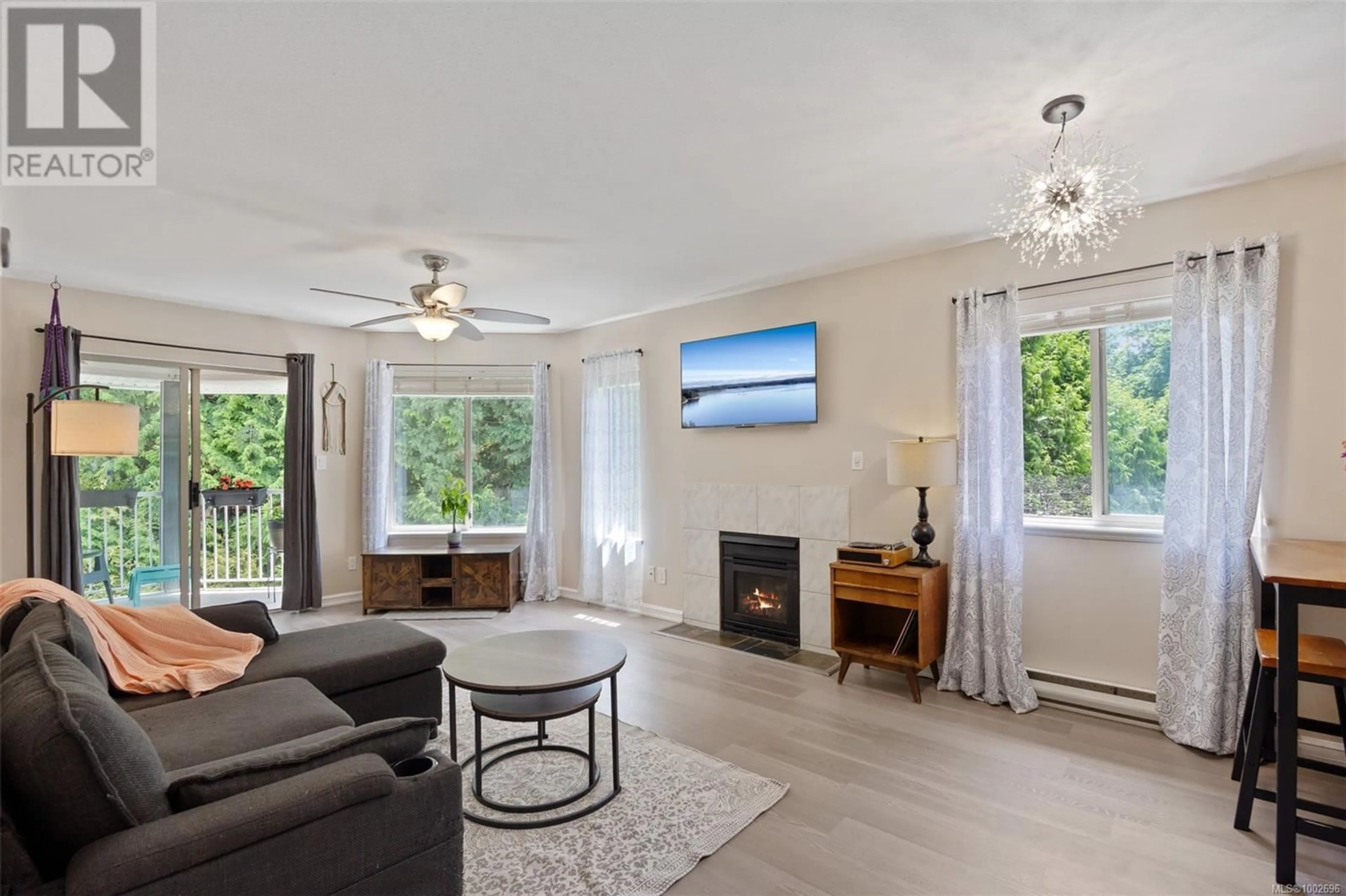 Living room with furniture, wood/laminate floor for 301 - 4685 ALDERWOOD PLACE, Courtenay British Columbia V9N9A1
