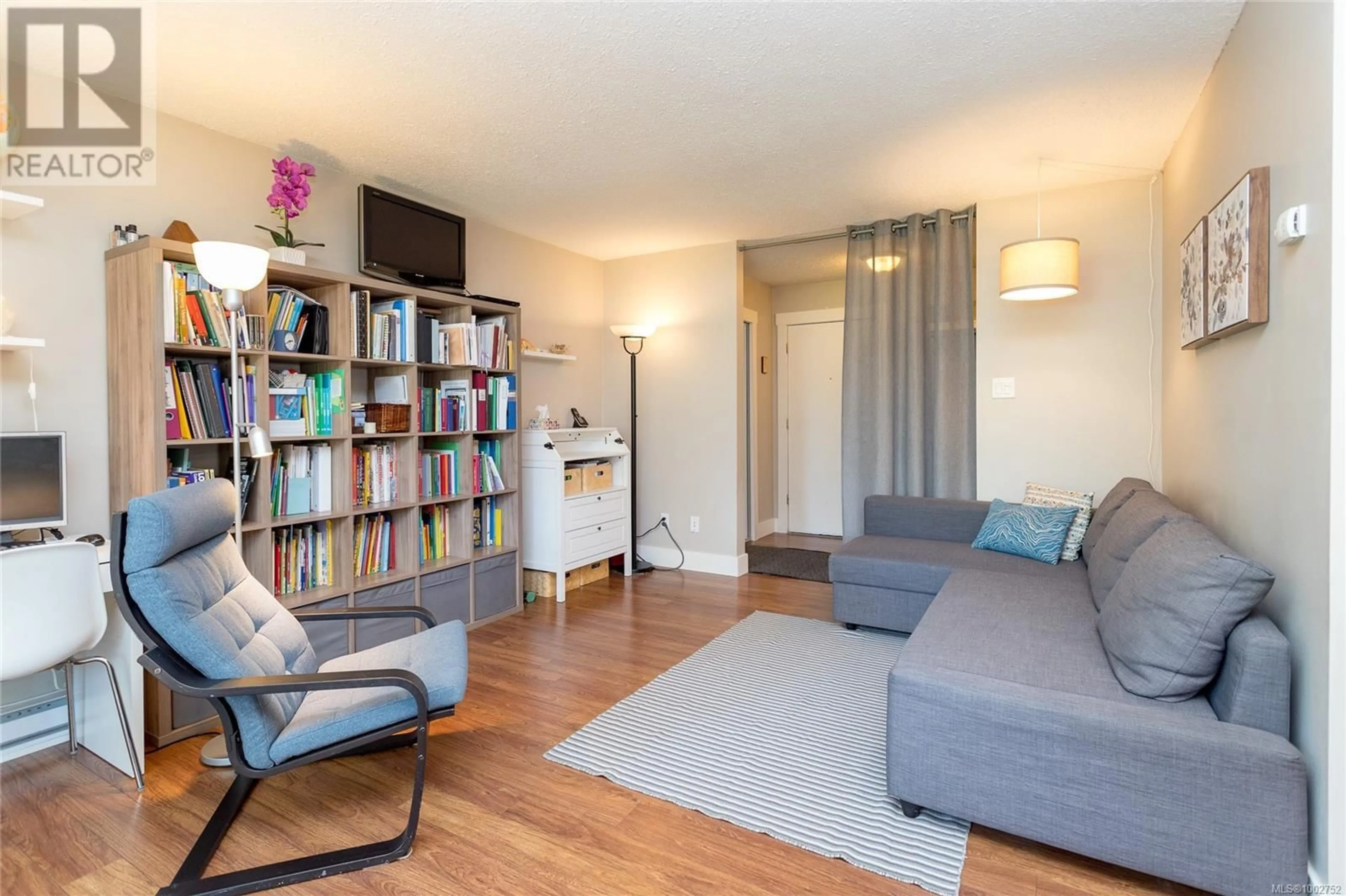 Living room with furniture, wood/laminate floor for 117 - 900 TOLMIE AVENUE, Saanich British Columbia V8X3W6