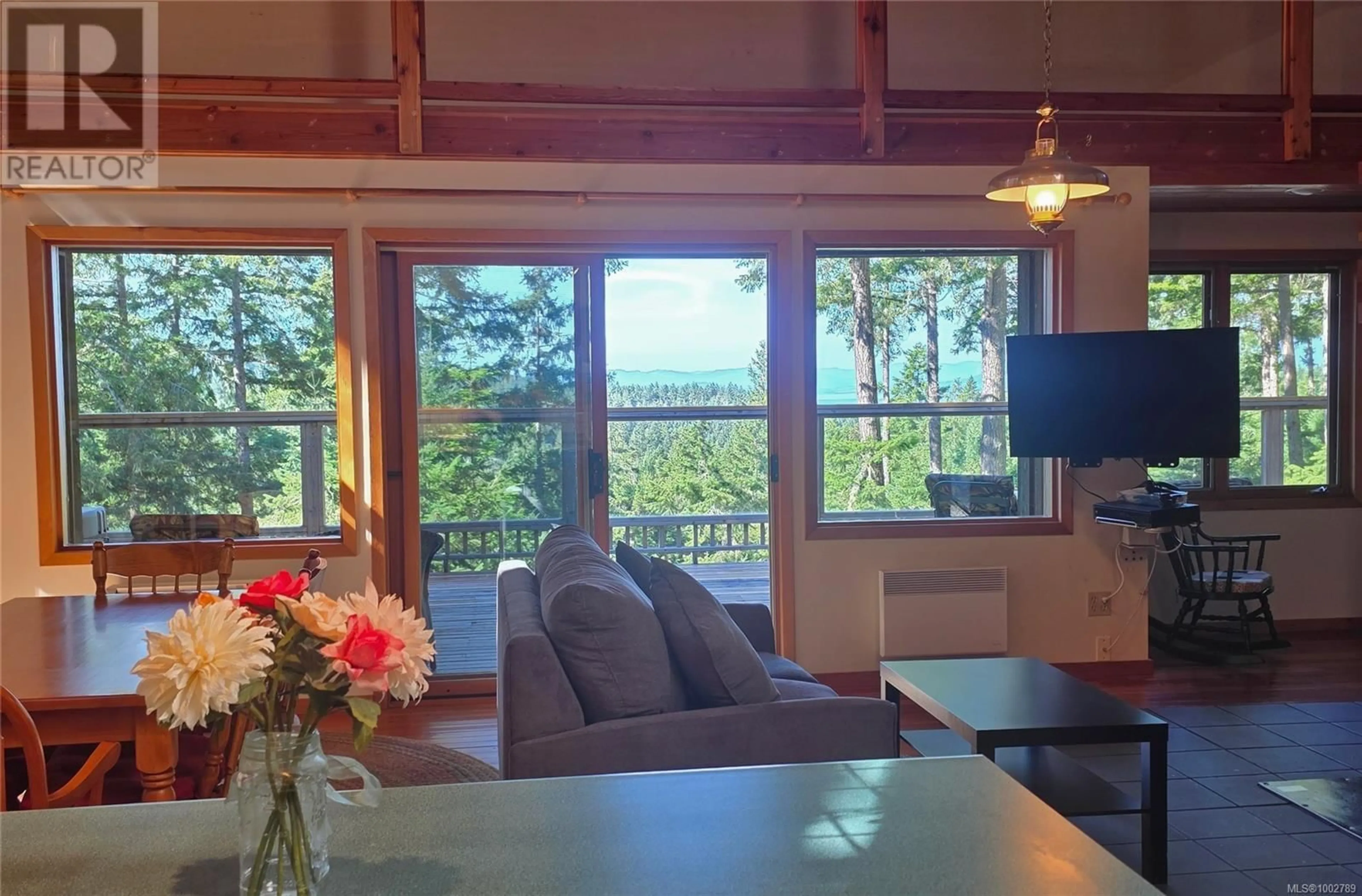Living room with furniture, wood/laminate floor for 3350 PORT WASHINGTON ROAD, Pender Island British Columbia V0N2M1