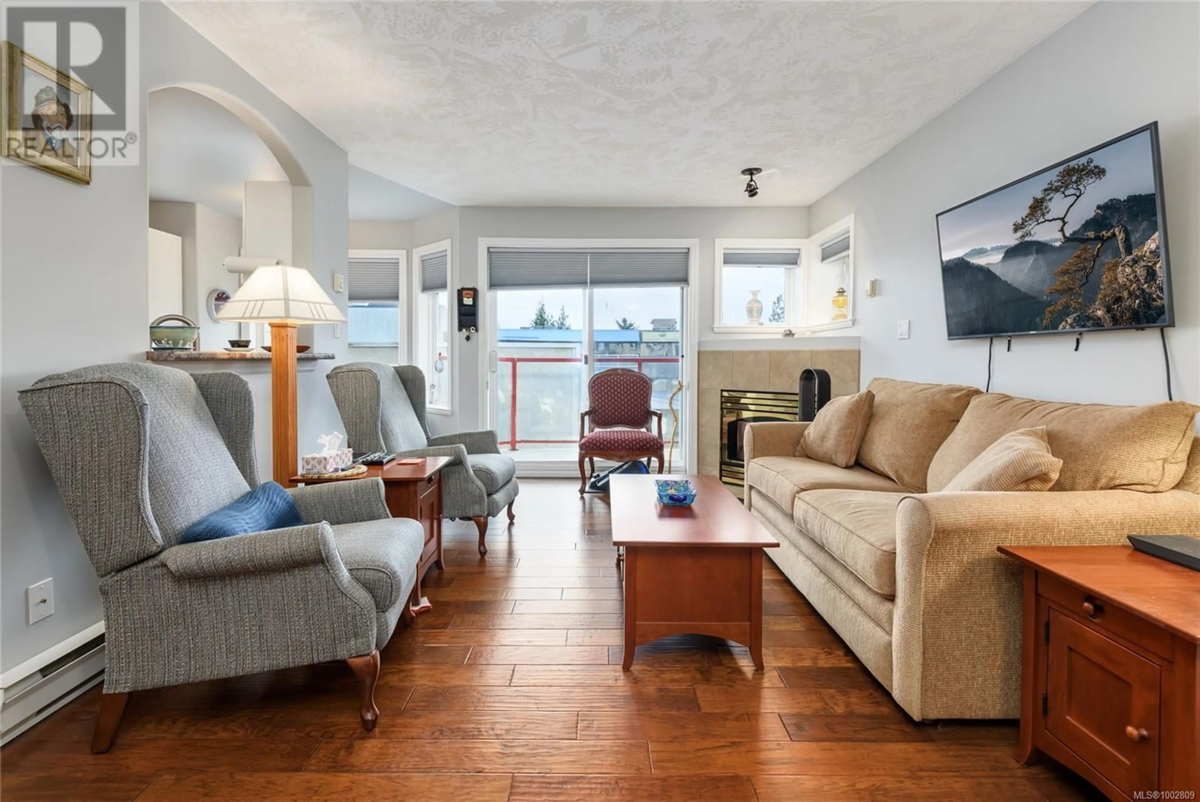 Living room with furniture, wood/laminate floor for 201 - 1811 COMOX AVENUE, Comox British Columbia V9M3L9