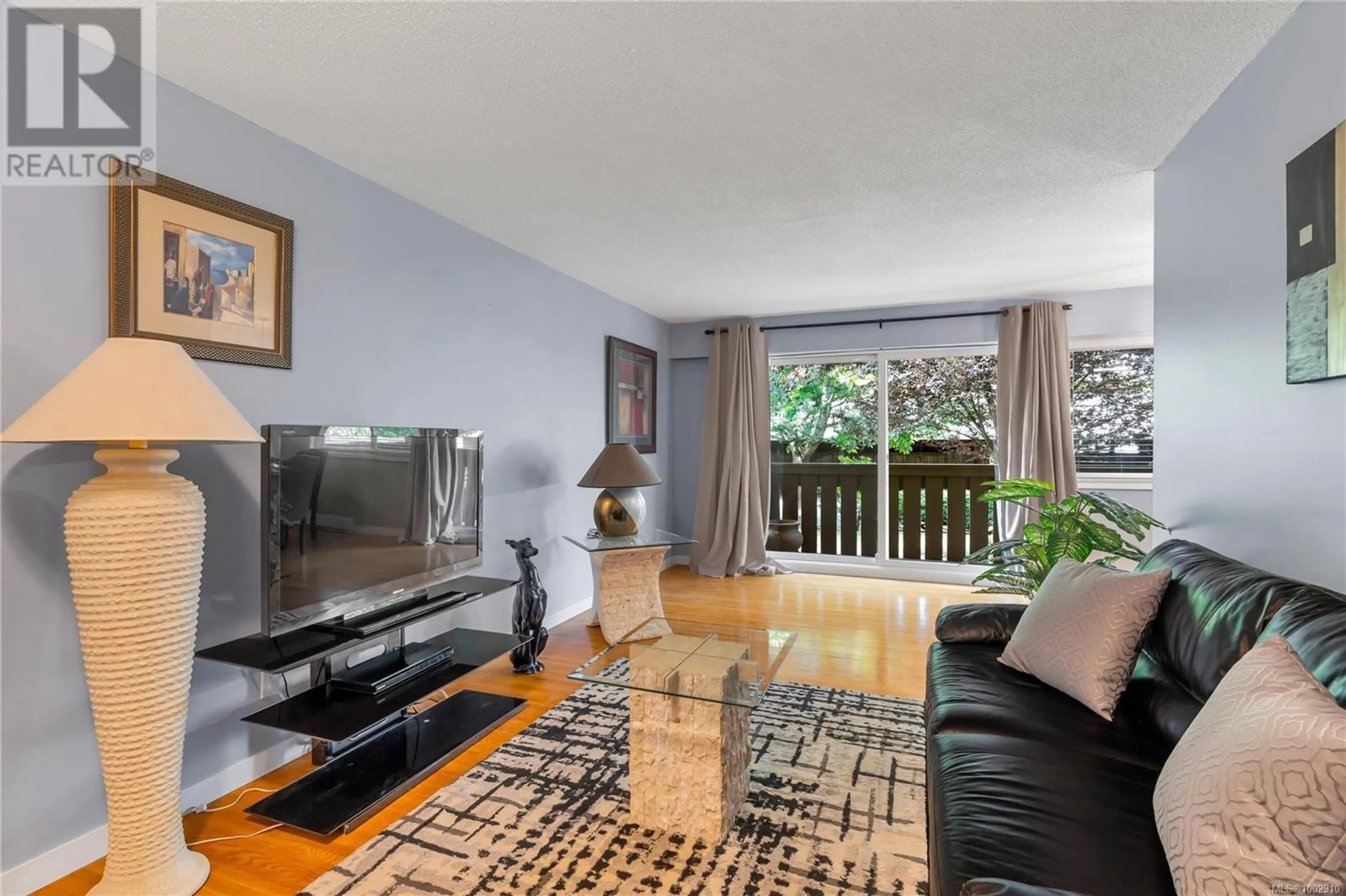 Living room with furniture, wood/laminate floor for 103 - 241 MCKINSTRY ROAD, Duncan British Columbia V9L3L3