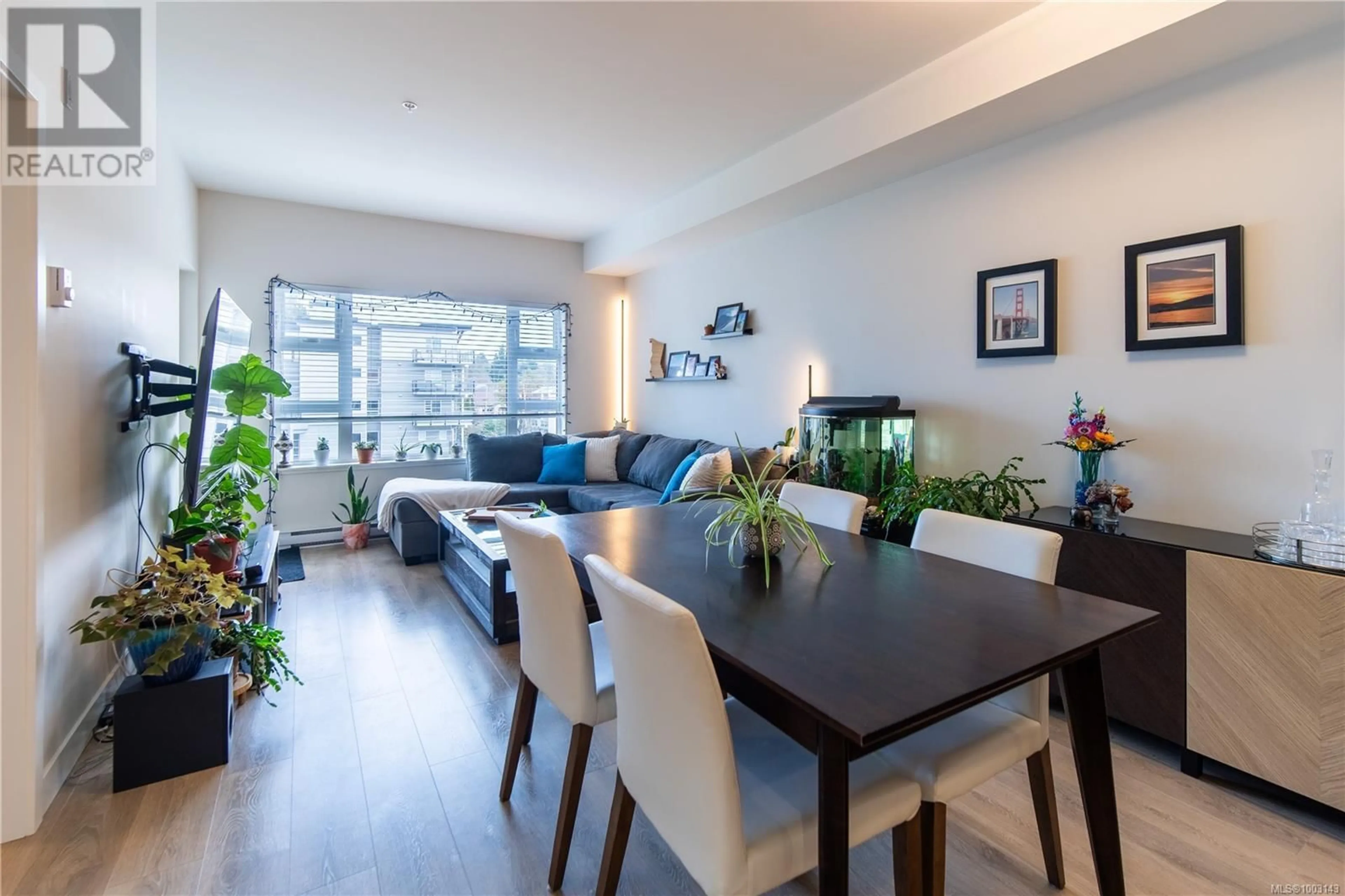 Living room with furniture, wood/laminate floor for 404 - 3333 GLASGOW AVENUE, Saanich British Columbia V8X1M5