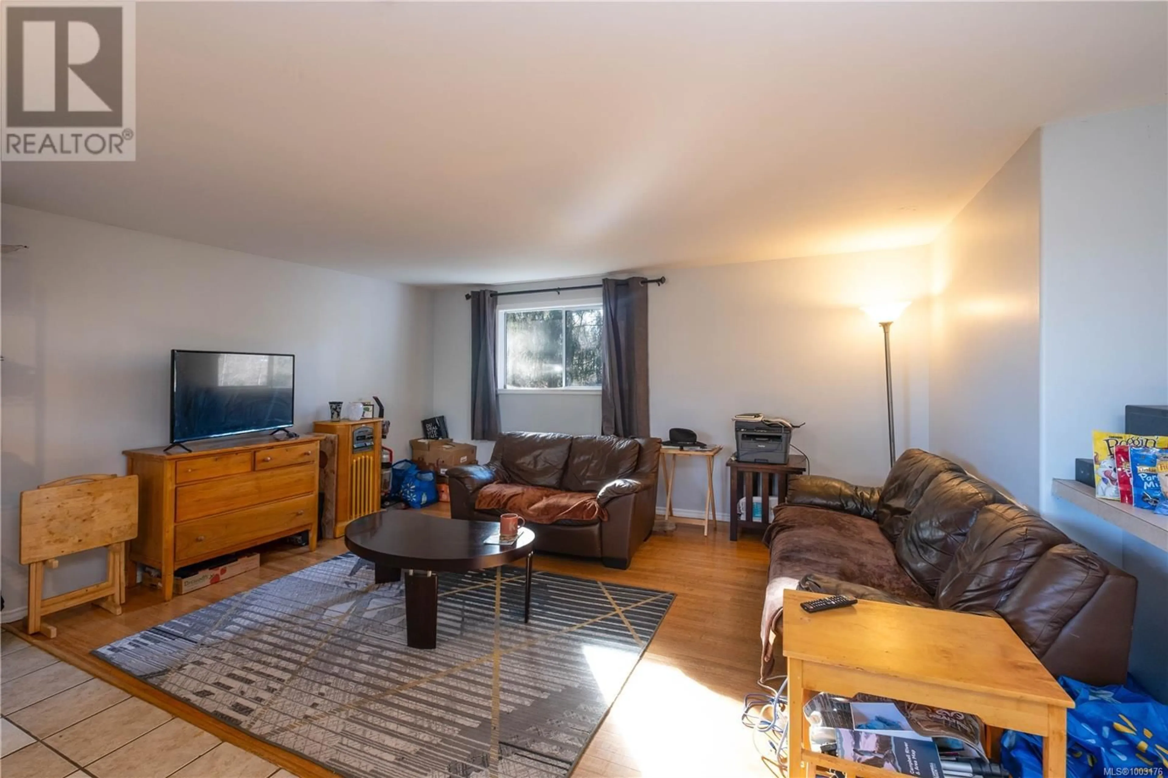 Living room with furniture, wood/laminate floor for 3666 MACAULAY ROAD, Oyster River British Columbia V9J1C7