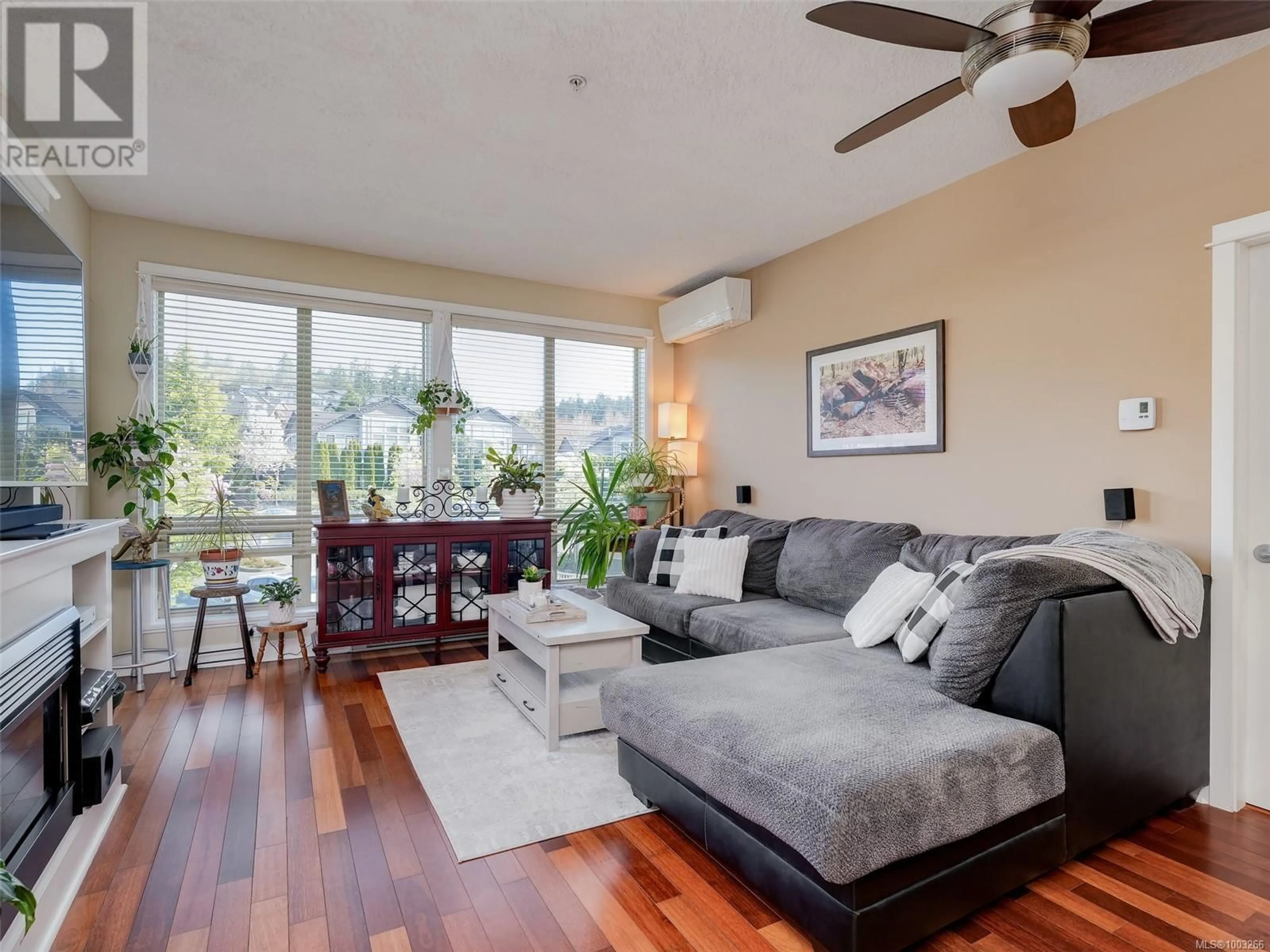 Living room with furniture, wood/laminate floor for 203 - 627 BROOKSIDE ROAD, Colwood British Columbia V8Y2S2