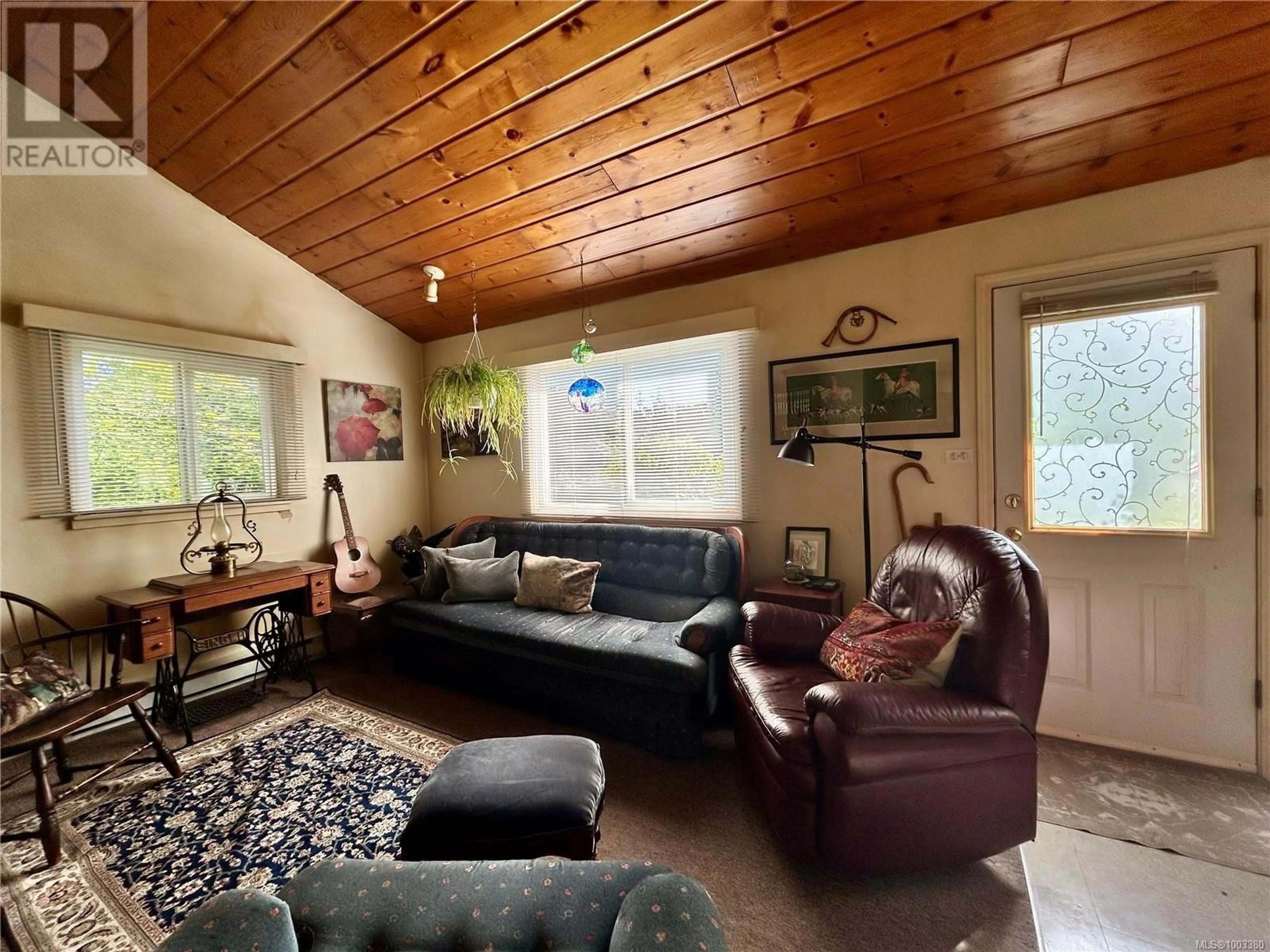 Living room with furniture, wood/laminate floor for 4760 HEADQUARTERS ROAD, Courtenay British Columbia V9N7J3