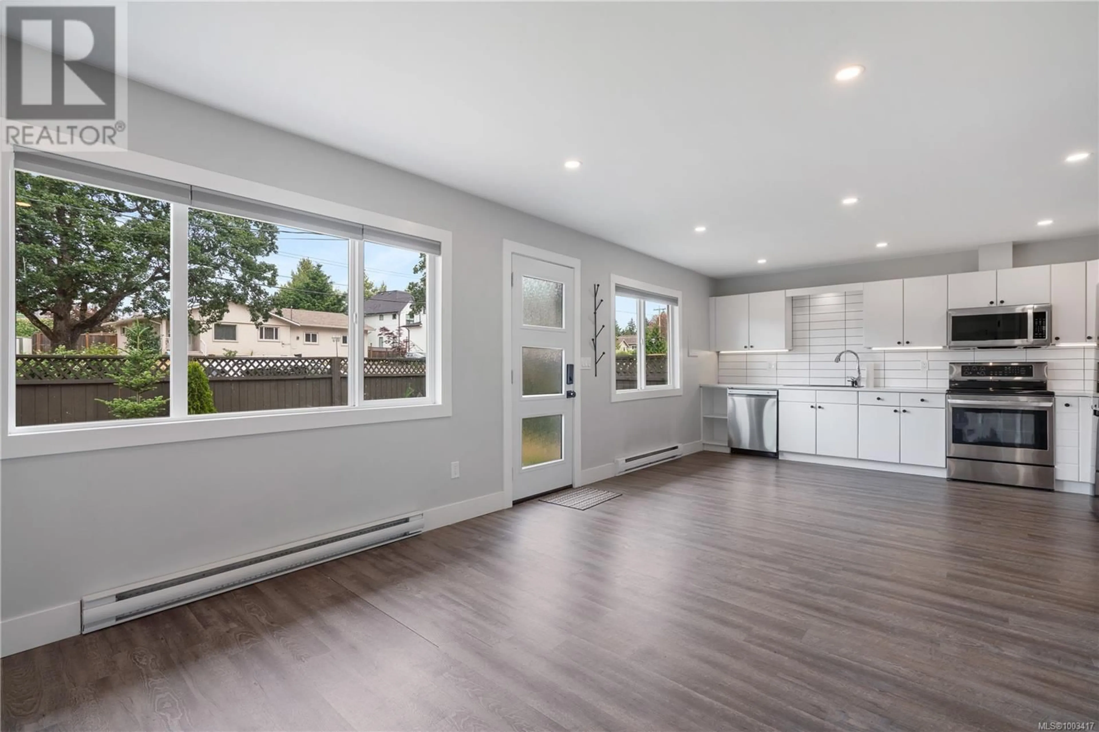 Open concept kitchen, wood/laminate floor for 641 STRANDLUND AVENUE, Langford British Columbia V9B3G1