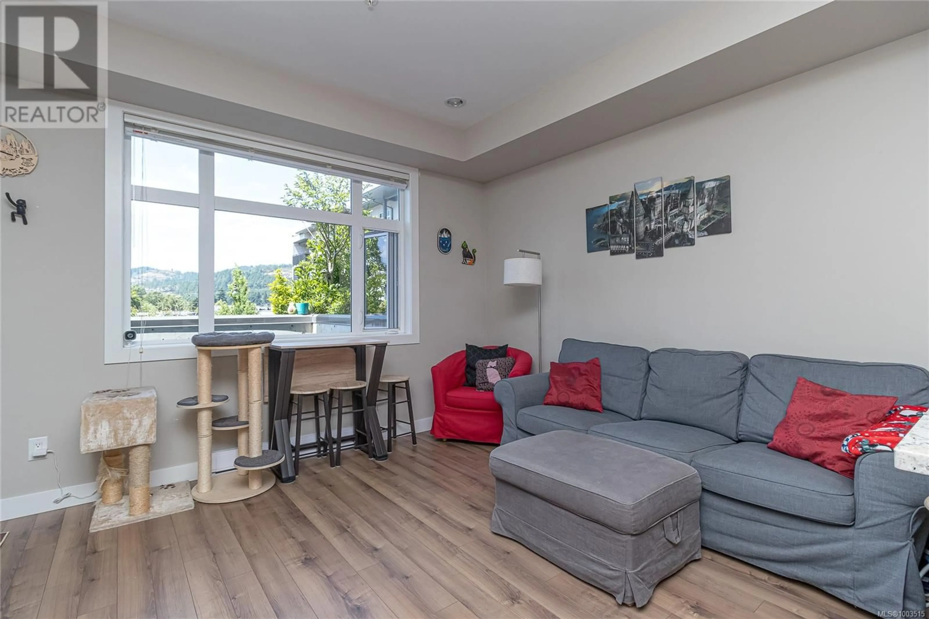 Living room with furniture, wood/laminate floor for 203 - 2655 SOOKE ROAD, Langford British Columbia V9B1Y3