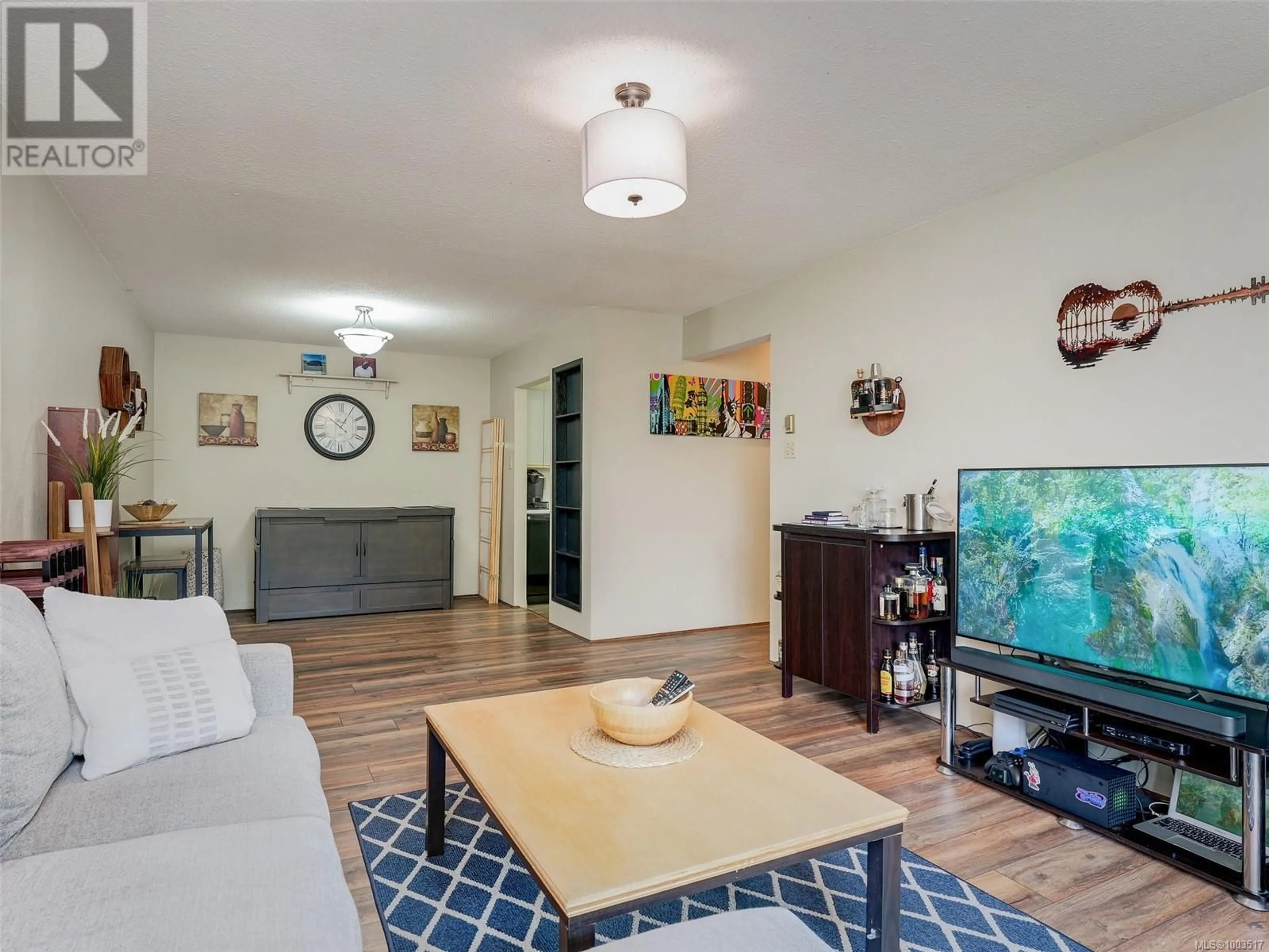 Living room with furniture, wood/laminate floor for 319 - 1005 MCKENZIE AVENUE, Saanich British Columbia V8X4A9