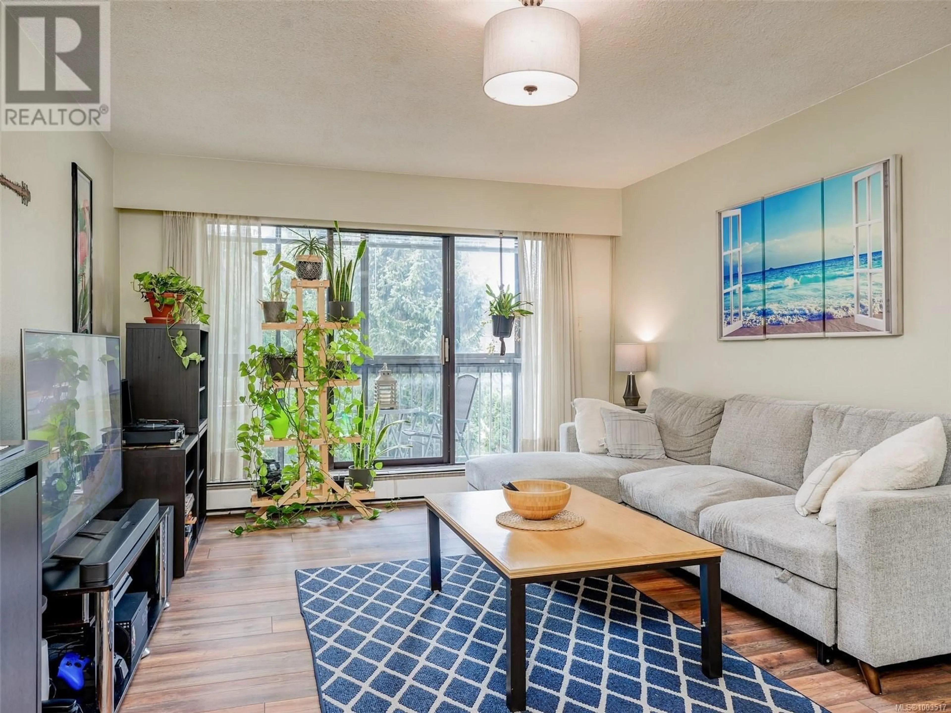 Living room with furniture, wood/laminate floor for 319 - 1005 MCKENZIE AVENUE, Saanich British Columbia V8X4A9