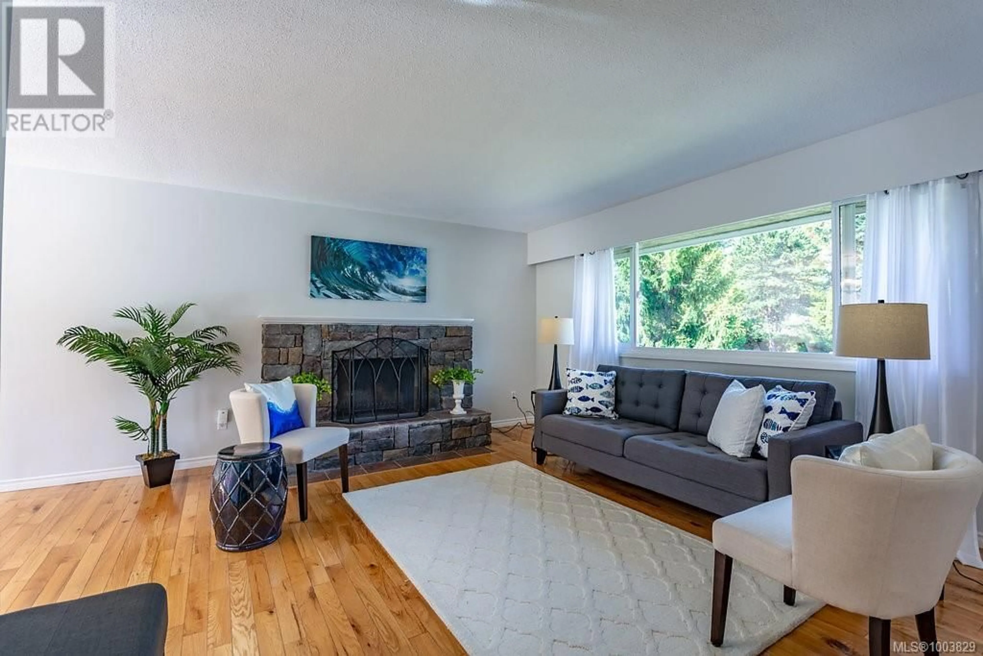 Living room with furniture, wood/laminate floor for 6743 WENDONNA PLACE, Central Saanich British Columbia V8M1A5
