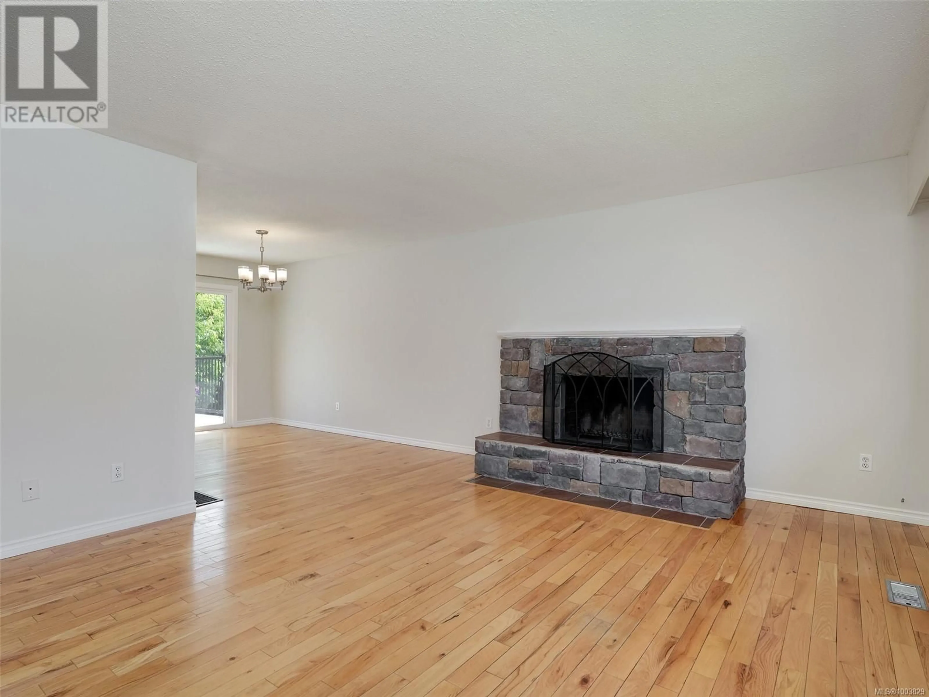 Living room with furniture, wood/laminate floor for 6743 WENDONNA PLACE, Central Saanich British Columbia V8M1A5