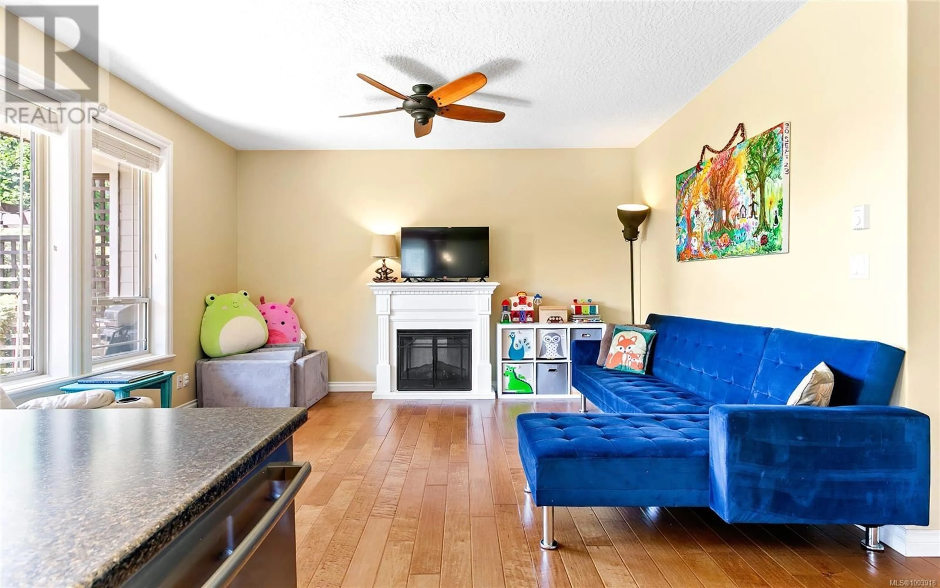 Living room with furniture, wood/laminate floor for 105 - 6591 ARRANWOOD DRIVE, Sooke British Columbia V9Z0W4
