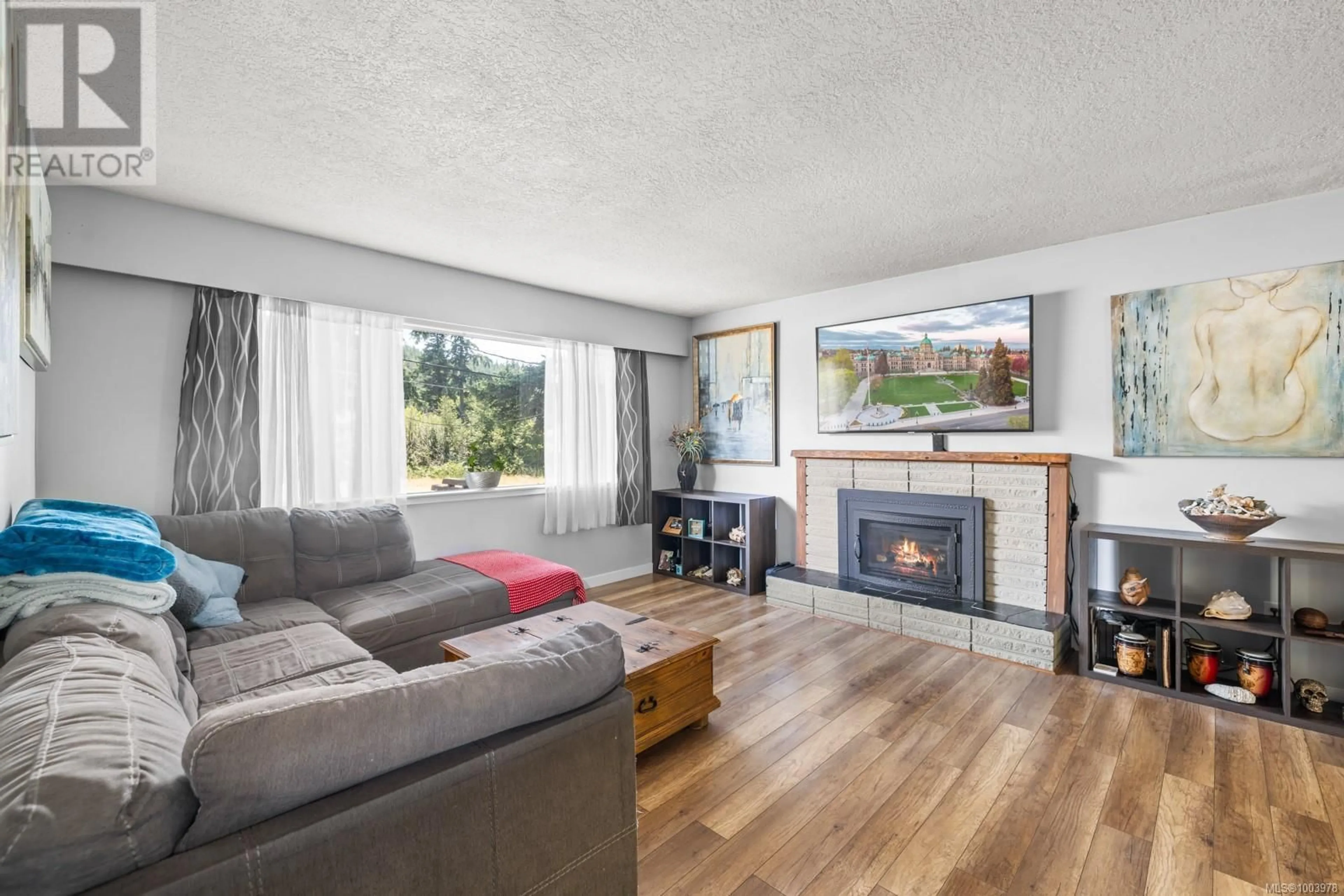 Living room with furniture, wood/laminate floor for 2640 SOOKE ROAD, Langford British Columbia V9B1Y4