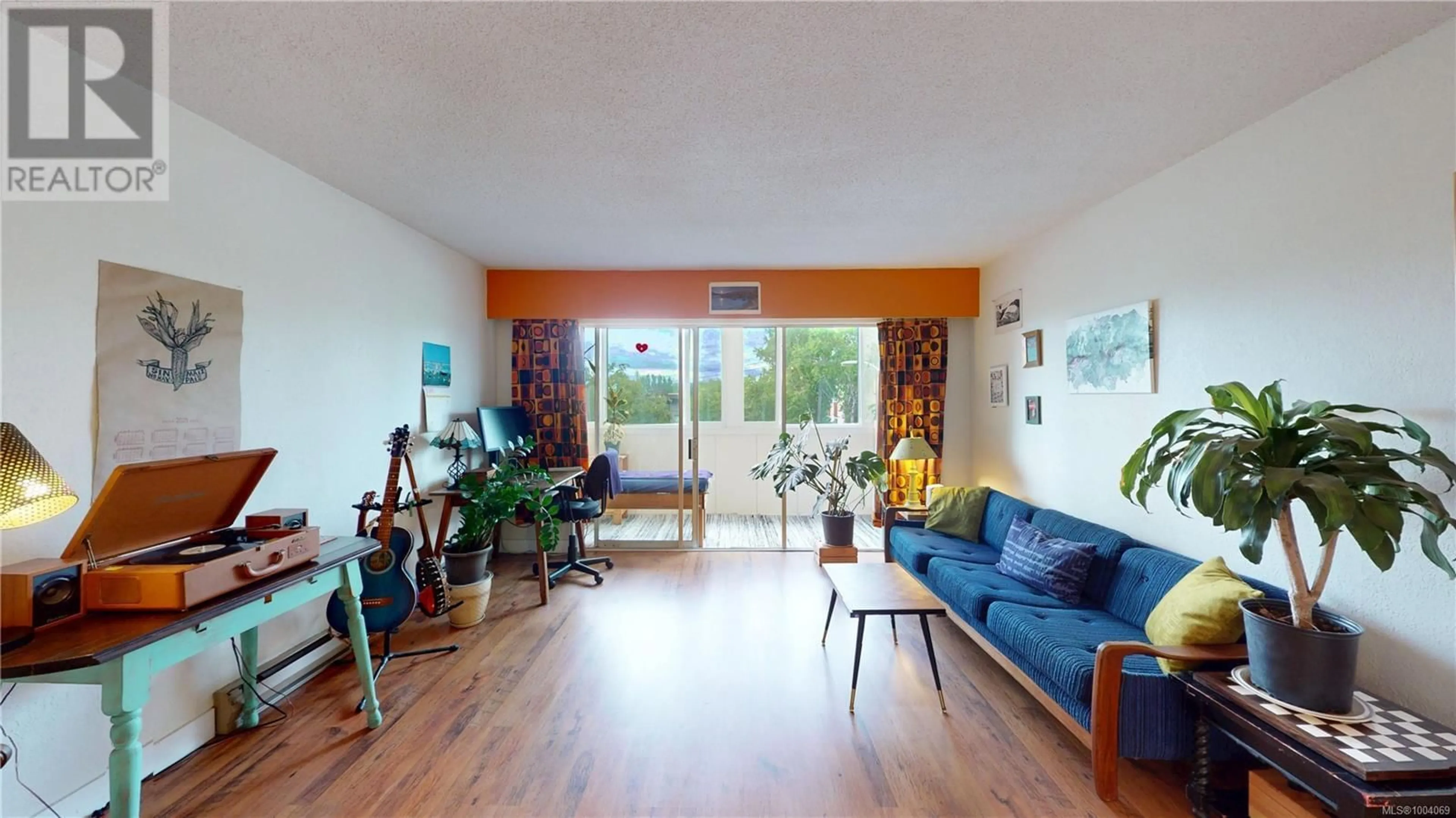 Living room with furniture, wood/laminate floor for 203 - 1012 PAKINGTON STREET, Victoria British Columbia V8V3A1
