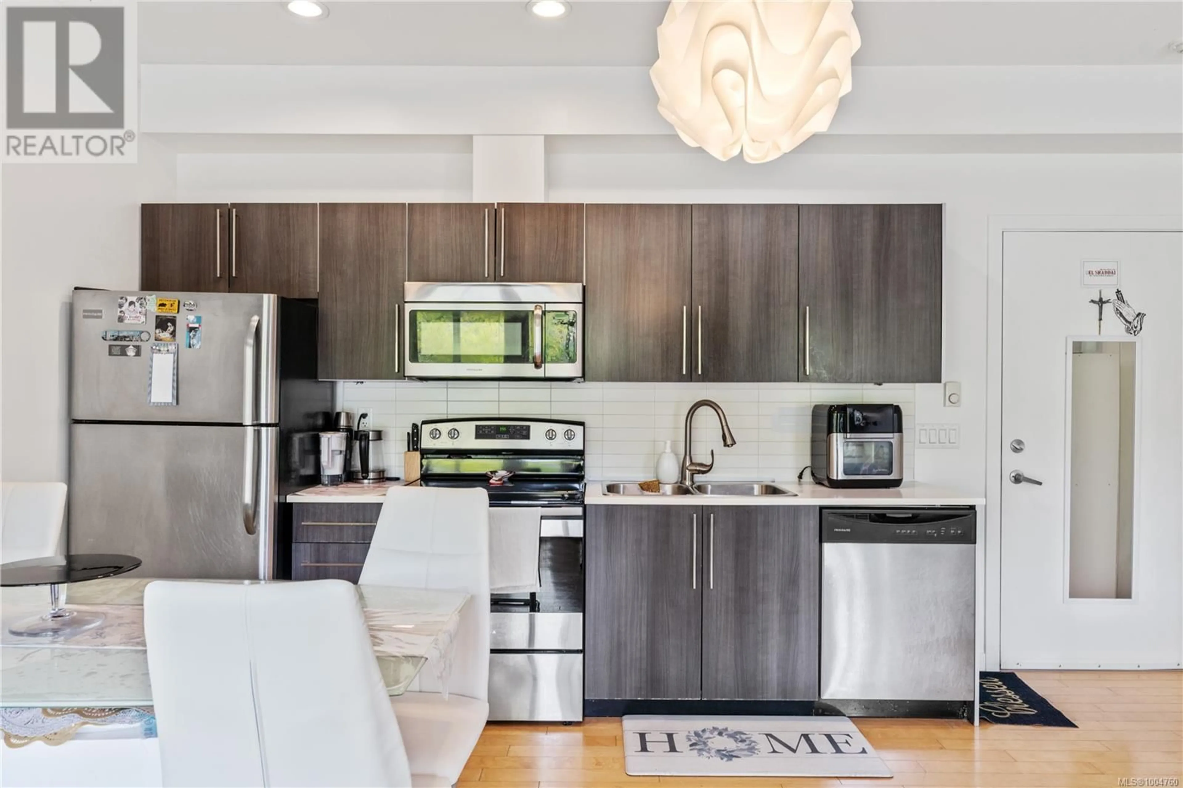 Open concept kitchen, wood/laminate floor for 207 - 4050 DOUGLAS STREET, Saanich British Columbia V8X0A5