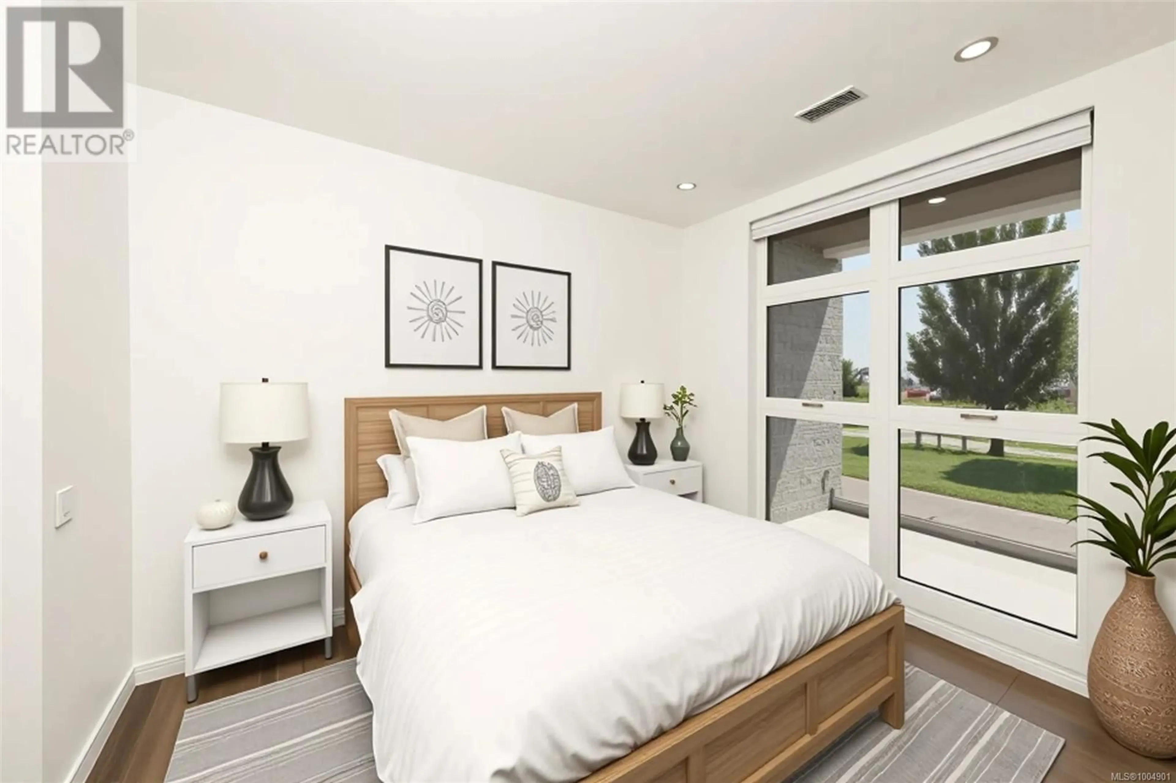 Bedroom with bed, wood/laminate floor for 204 - 9570 FIFTH STREET, Sidney British Columbia V8L2W5
