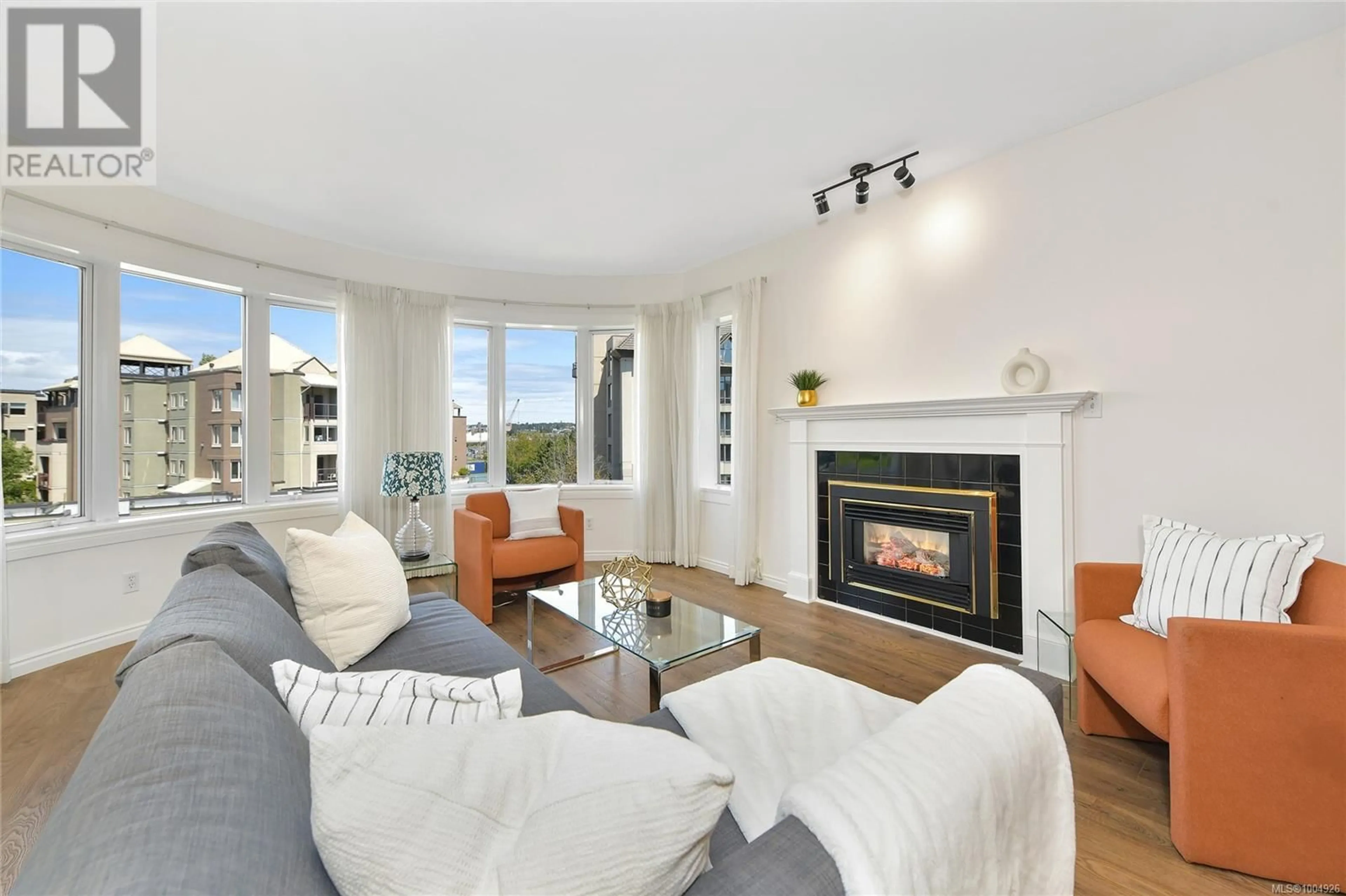 Living room with furniture, wood/laminate floor for 408 - 50 SONGHEES ROAD, Victoria British Columbia V9A7J4