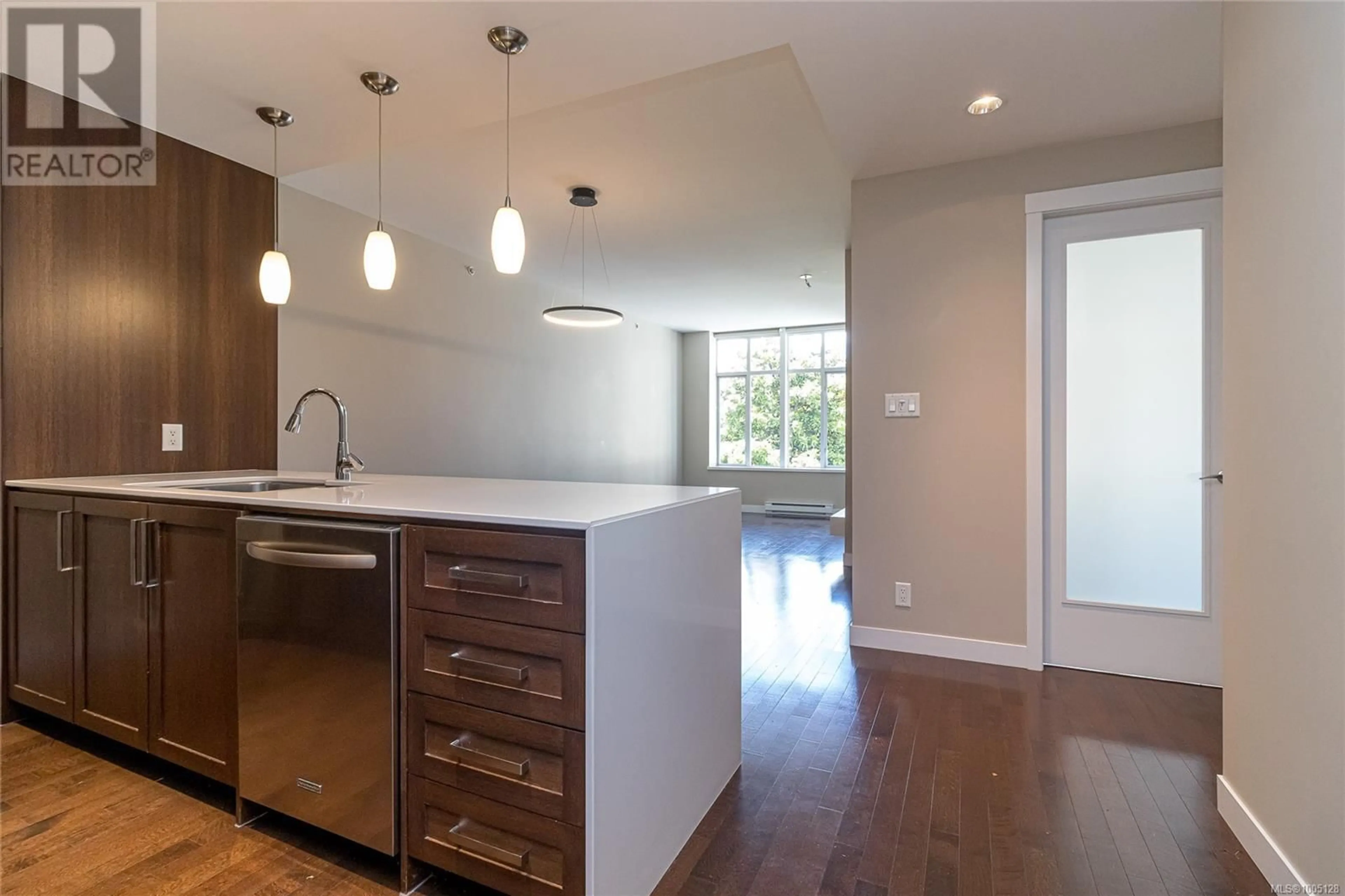 Open concept kitchen, wood/laminate floor for 215 - 999 BURDETT AVENUE, Victoria British Columbia V8V3G7