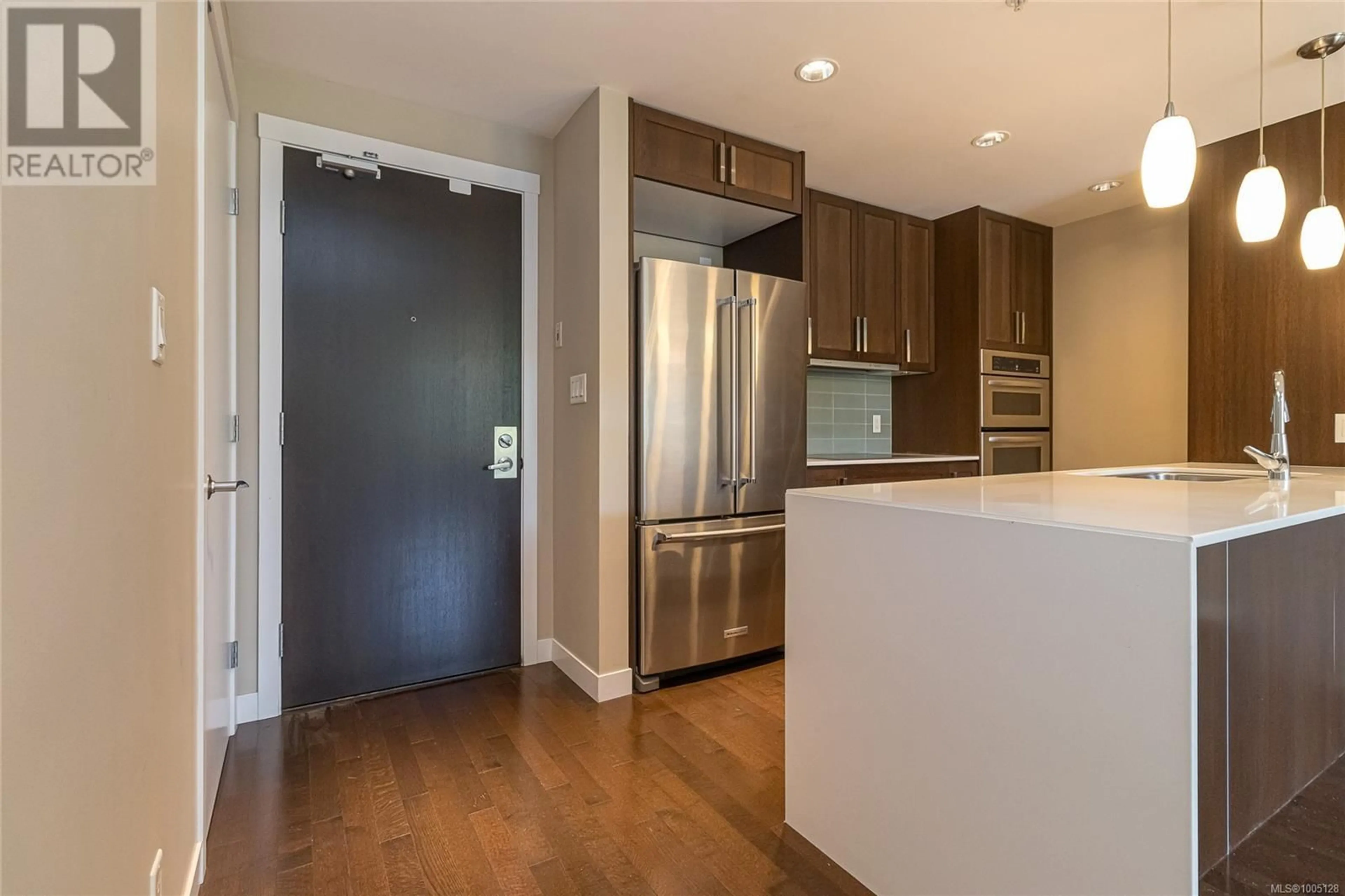Open concept kitchen, wood/laminate floor for 215 - 999 BURDETT AVENUE, Victoria British Columbia V8V3G7