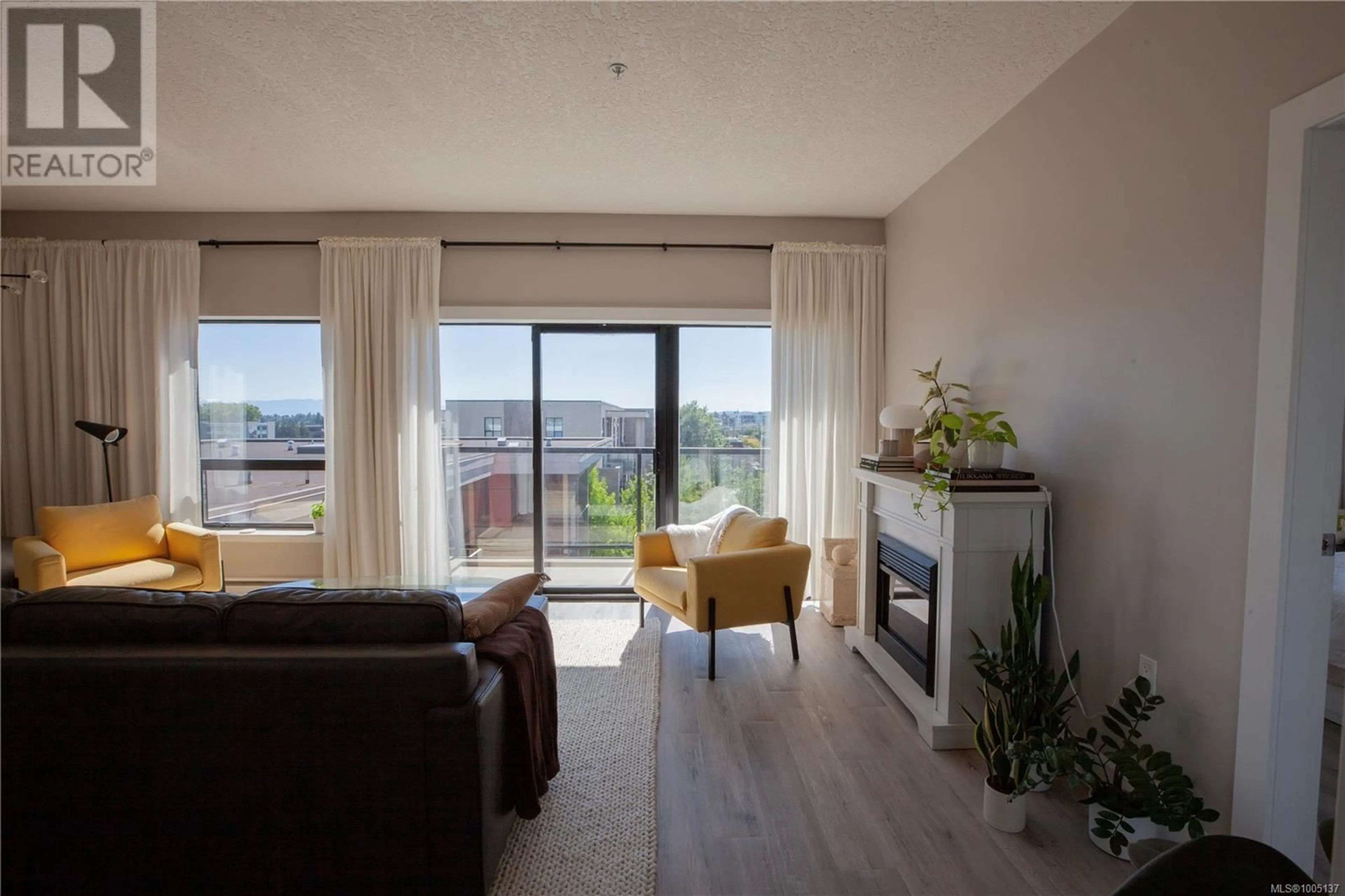 Living room with furniture, wood/laminate floor for 507 - 870 SHORT STREET, Saanich British Columbia V8X2V5